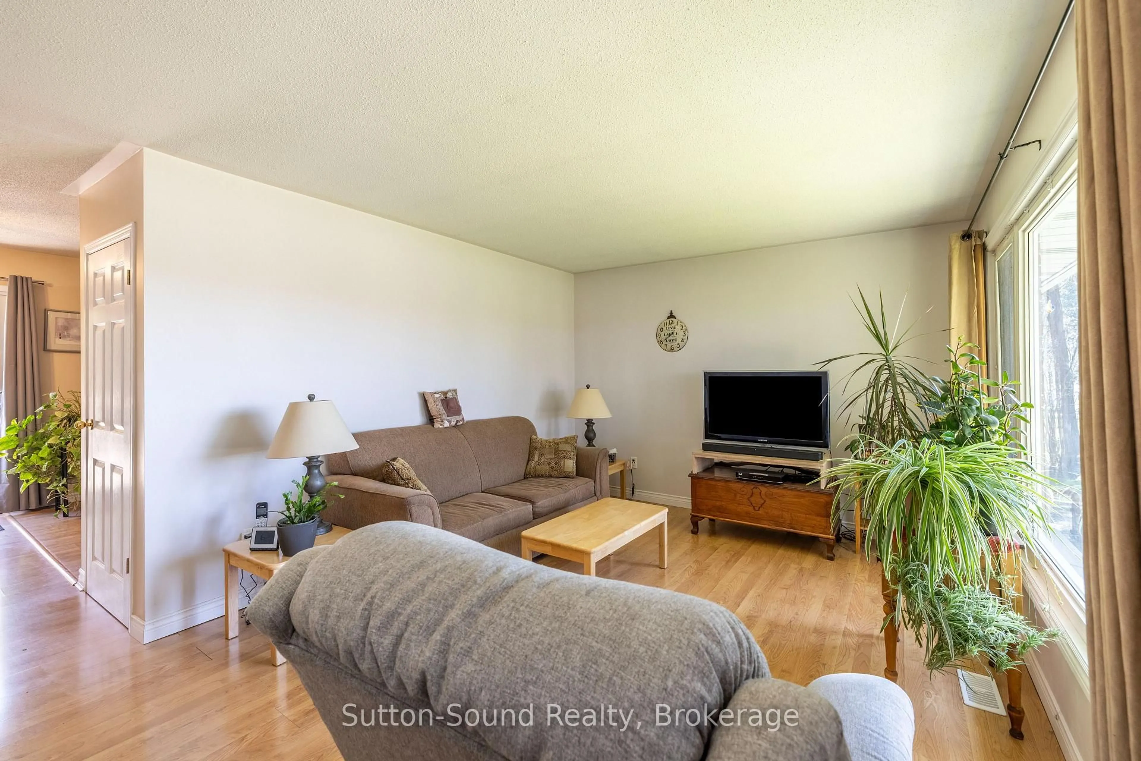 Living room with furniture, wood/laminate floor for 19589 Highway 6 Highway, South Bruce Peninsula Ontario N0H 2T0