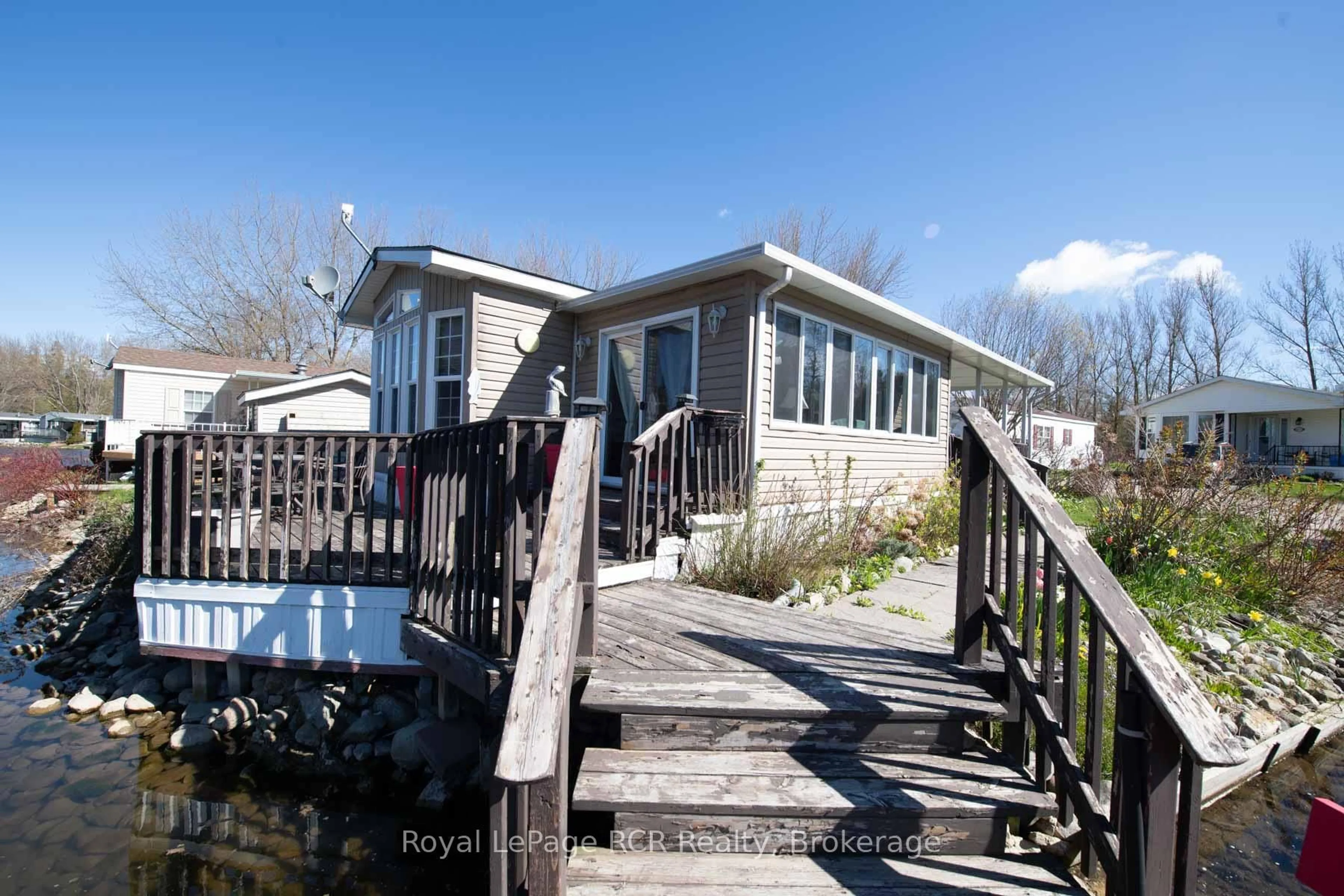 A pic from outside/outdoor area/front of a property/back of a property/a pic from drone, water/lake/river/ocean view for 61 LAKESIDE St, Wellington North Ontario N0G 2L0