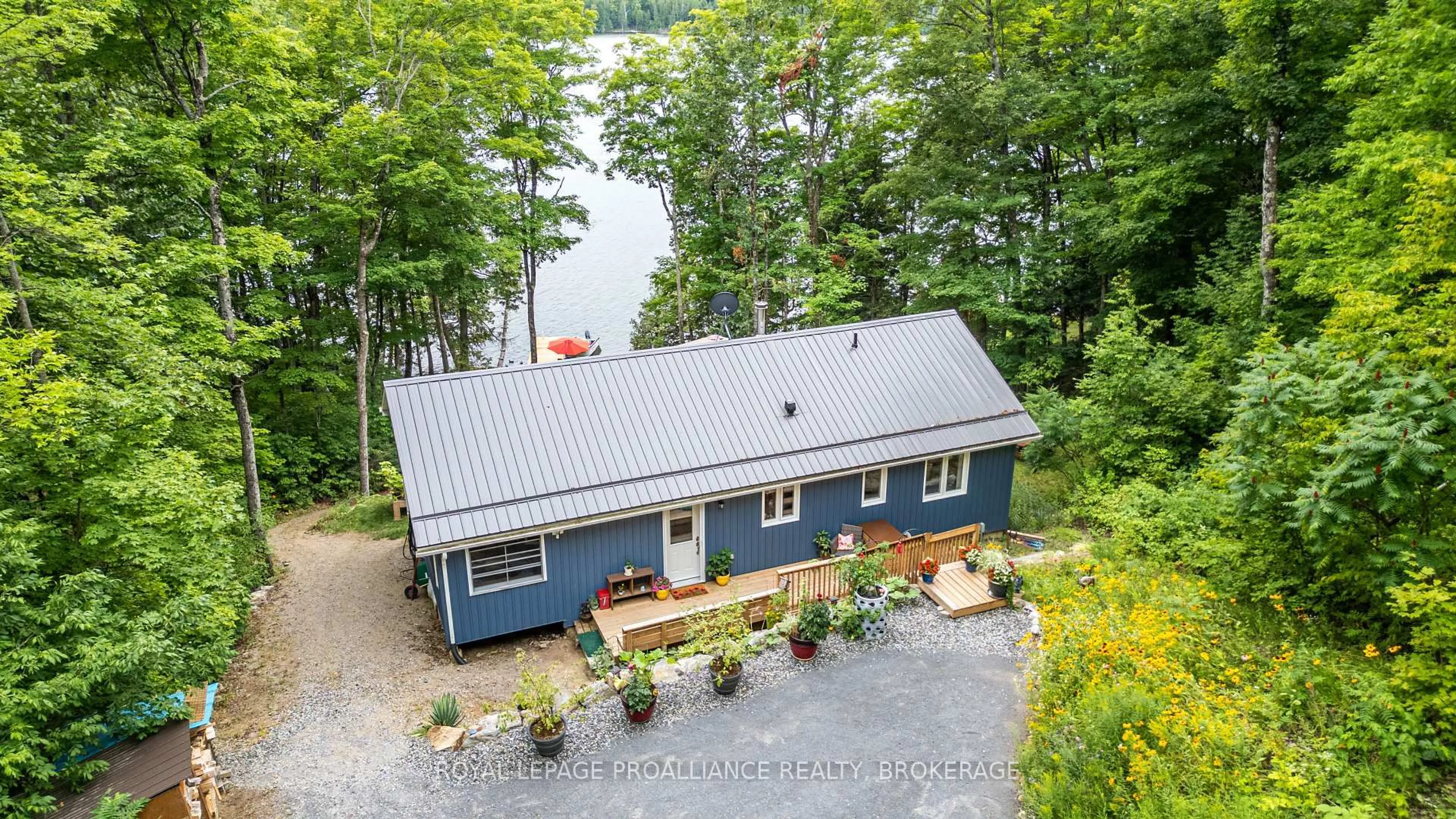 A pic from outside/outdoor area/front of a property/back of a property/a pic from drone, water/lake/river/ocean view for 1099 Almost Lane, Ardoch Ontario K0H 1C0