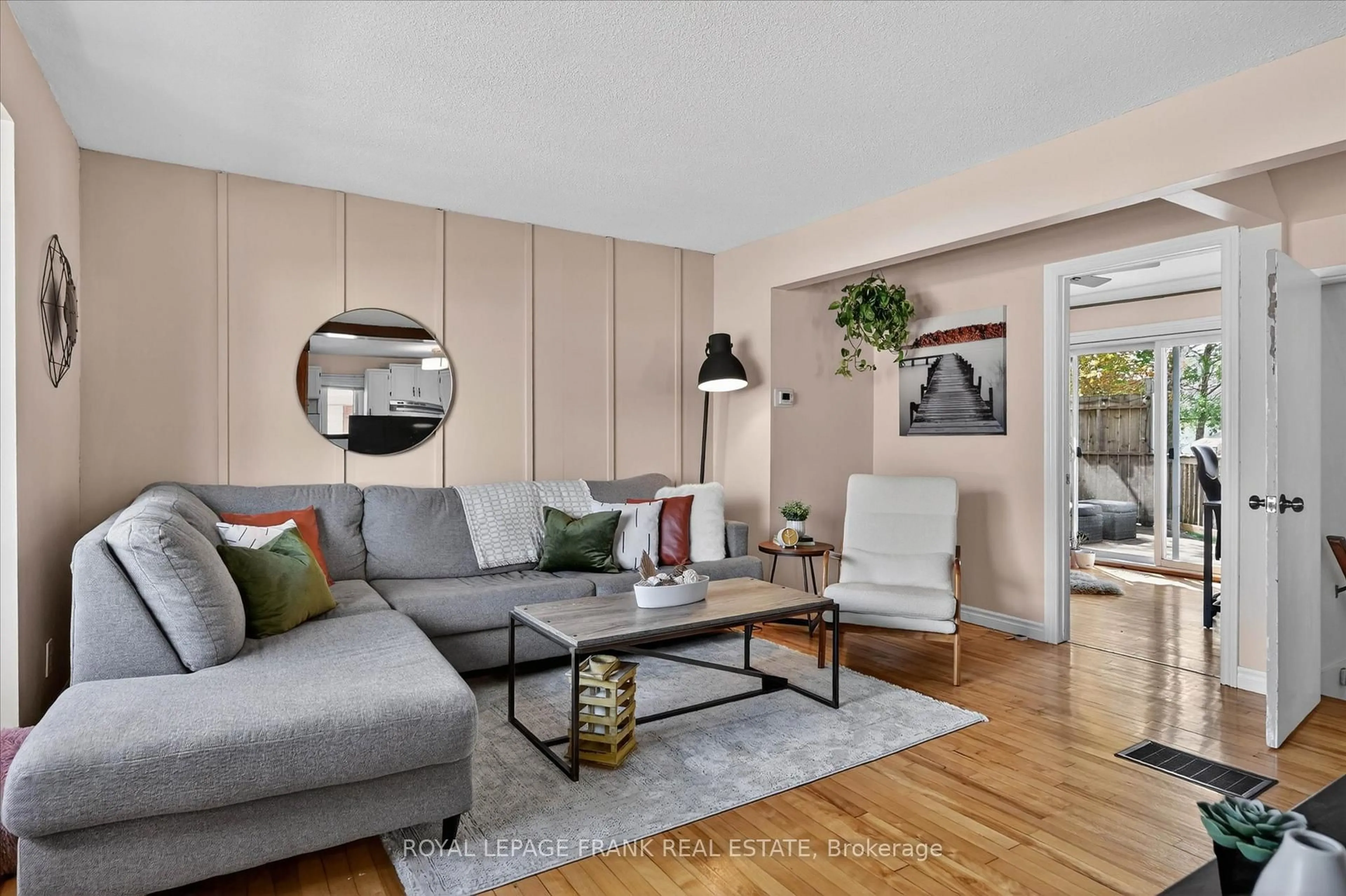 Living room with furniture, wood/laminate floor for 657 Mckellar St, Peterborough Ontario K9J 1R4