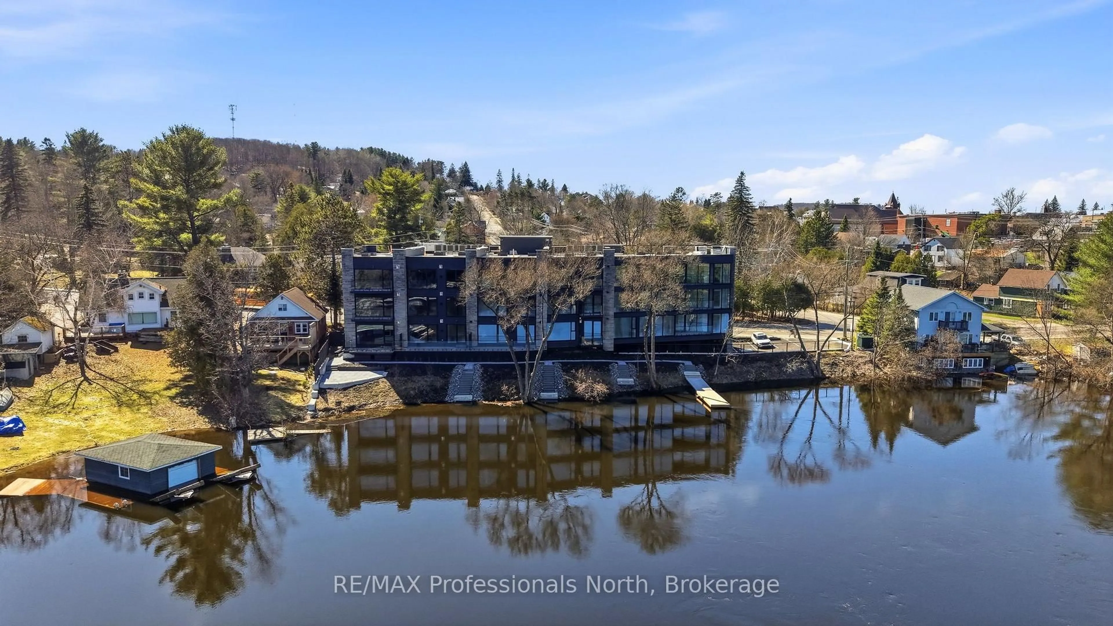 A pic from outside/outdoor area/front of a property/back of a property/a pic from drone, water/lake/river/ocean view for 32 BRUNEL Rd #303, Huntsville Ontario P1H 1P5