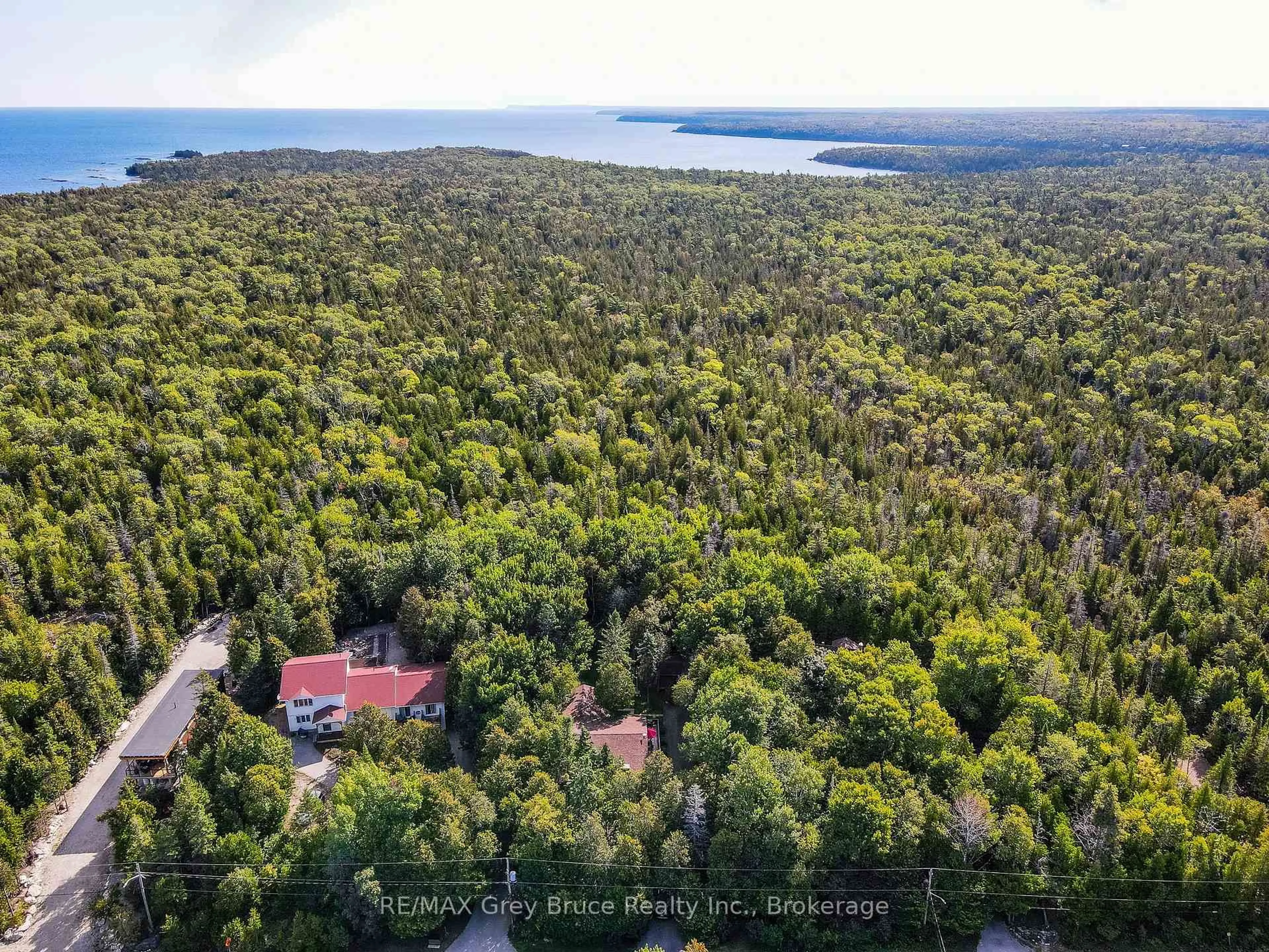 A pic from outside/outdoor area/front of a property/back of a property/a pic from drone, forest/trees view for 66 HARPUR Dr, Northern Bruce Peninsula Ontario N0H 2R0