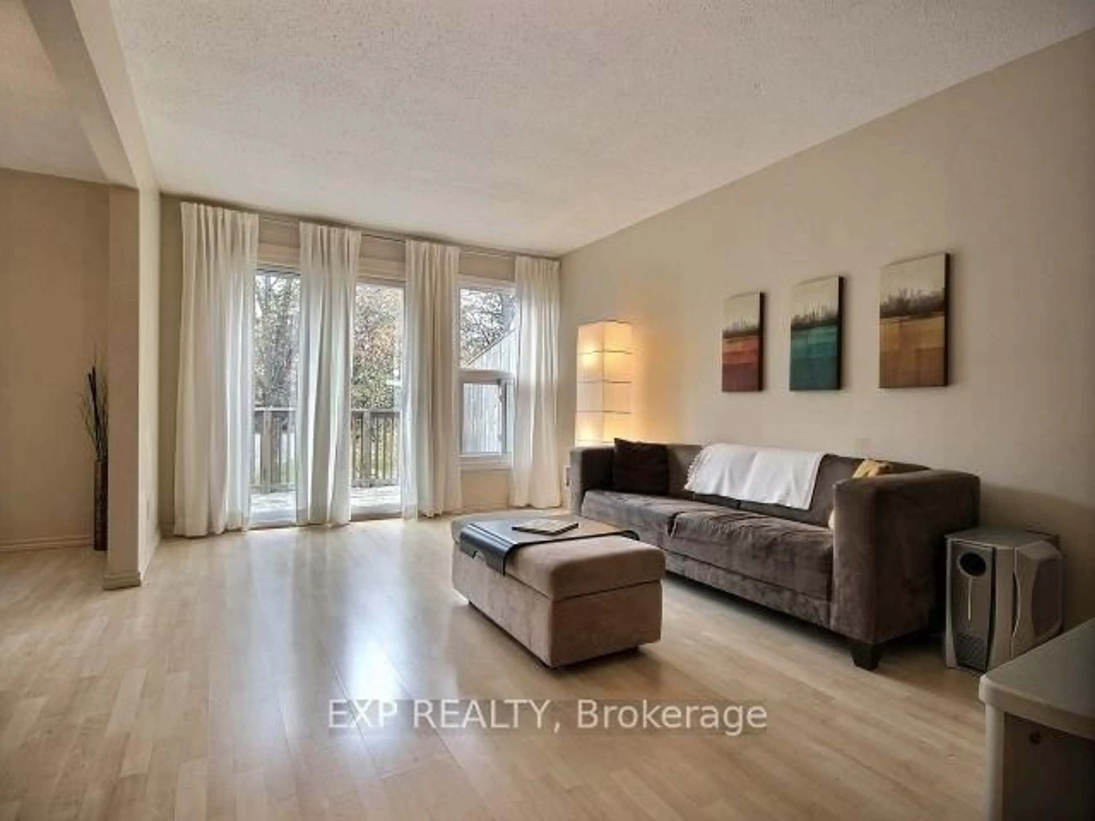 Living room with furniture, wood/laminate floor for 3415 Uplands Dr #29, Ottawa Ontario K1V 9N3