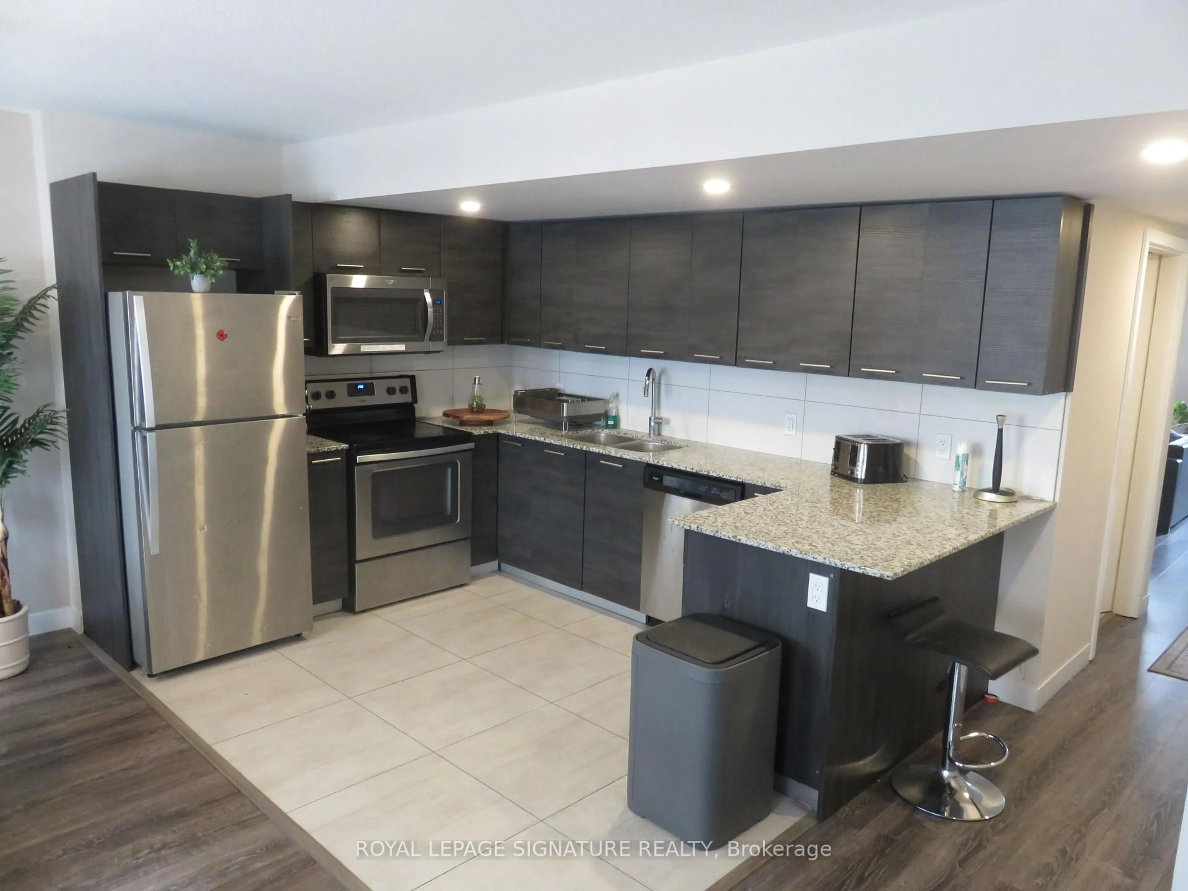 Open concept kitchen, ceramic/tile floor for 288 Albert St #216, Waterloo Ontario N2L 3T8