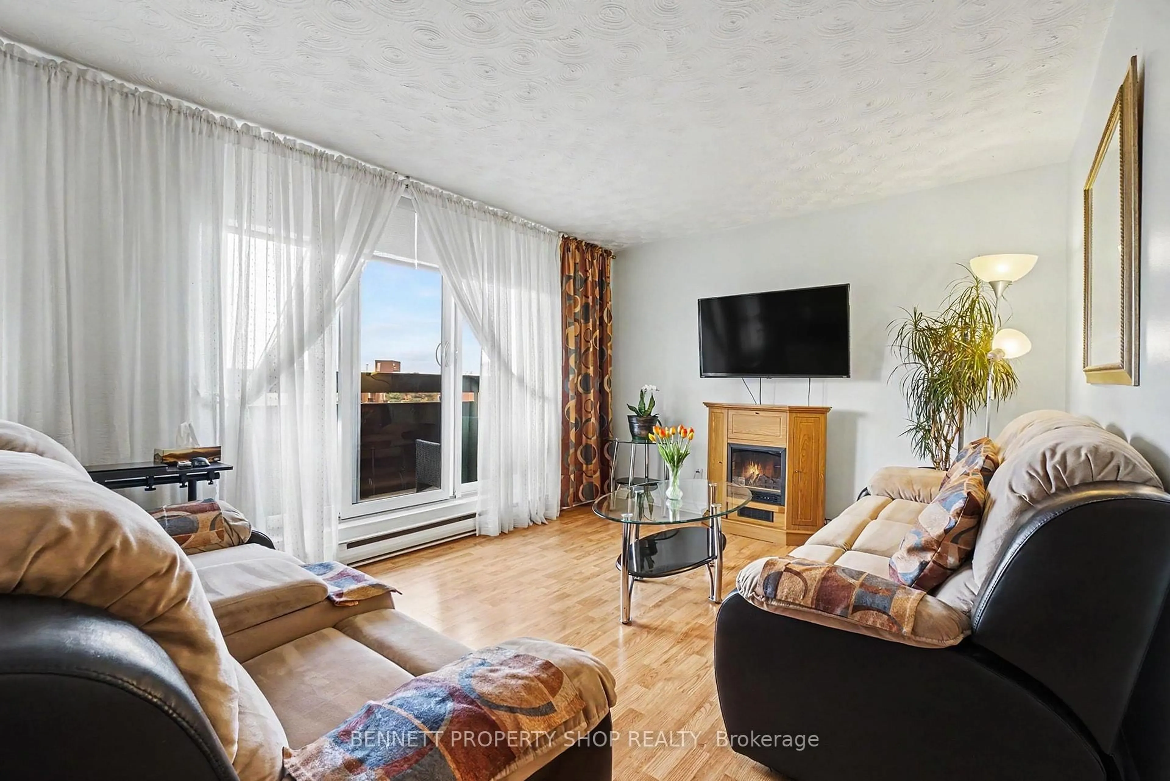 Living room with furniture, wood/laminate floor for 2000 Jasmine Cres #410, Ottawa Ontario K1J 8K4