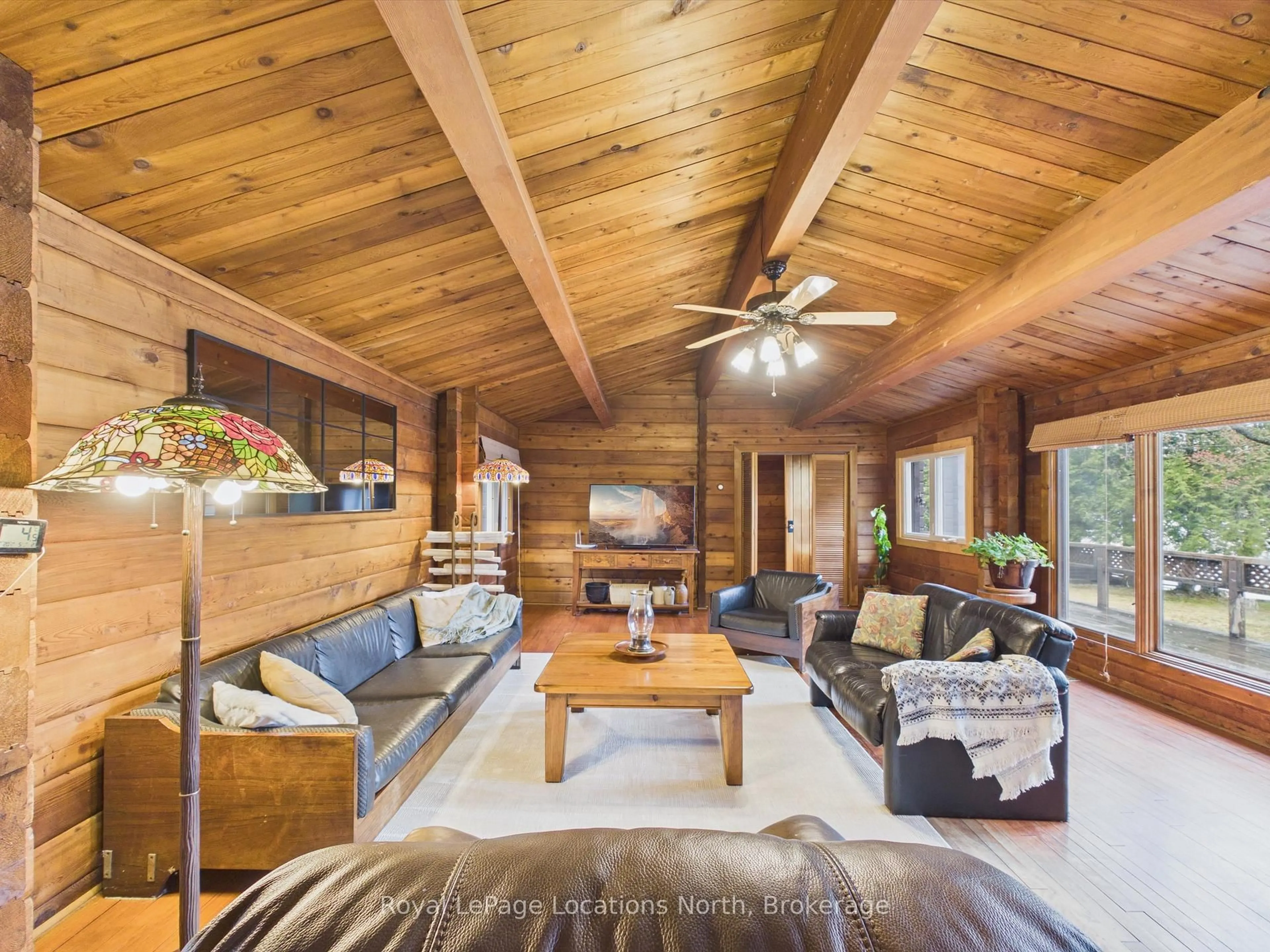 Living room with furniture, wood/laminate floor for 1027 Scott Lane, Lake of Bays Ontario P1H 2J6