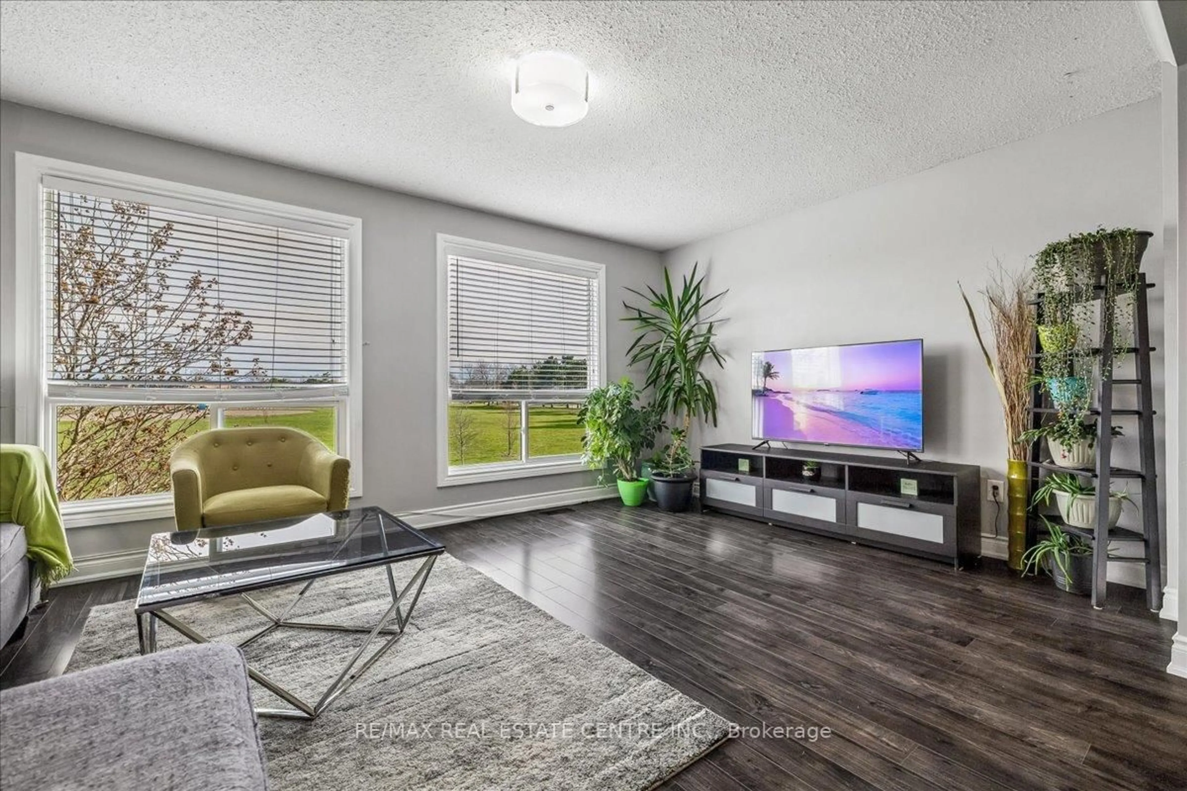 Living room with furniture, wood/laminate floor for 1155 Paramount Dr #49, Hamilton Ontario L8J 2N2