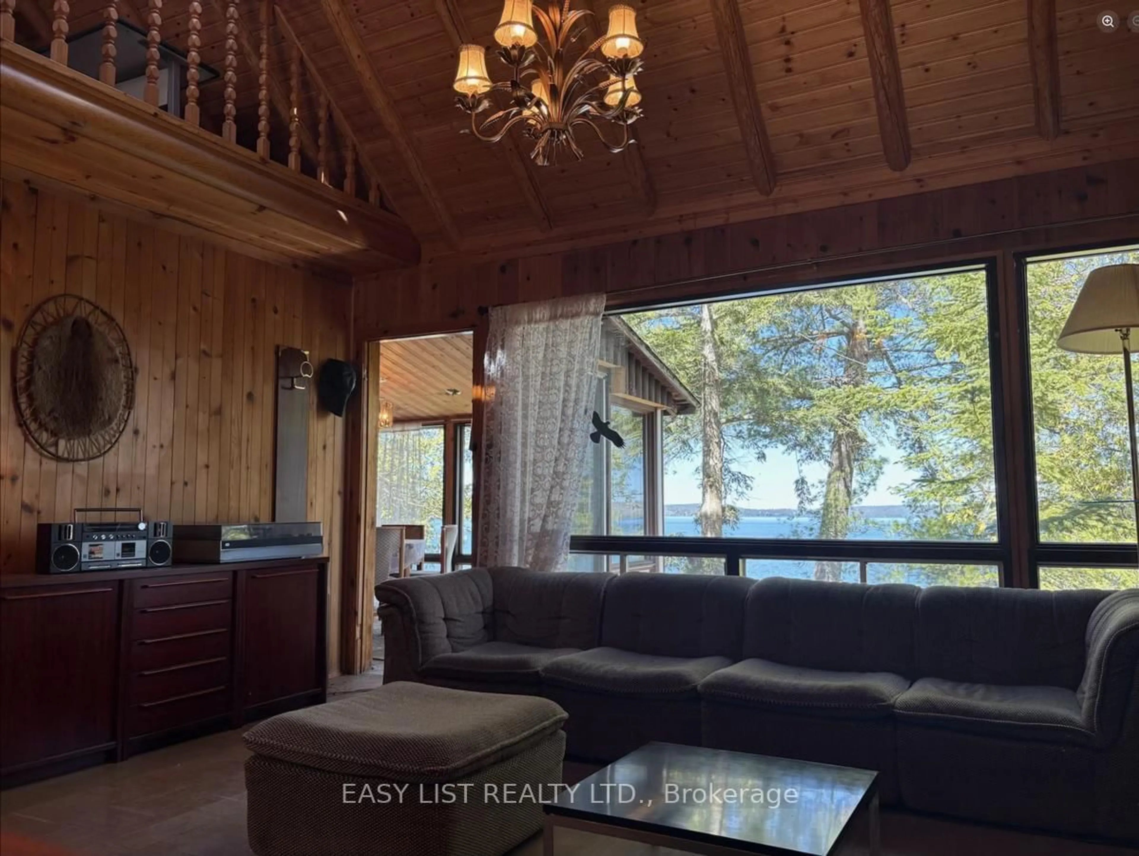 Living room with furniture, wood/laminate floor for 16304A 17 Highway, Huron Shores Ontario P0R 1H0