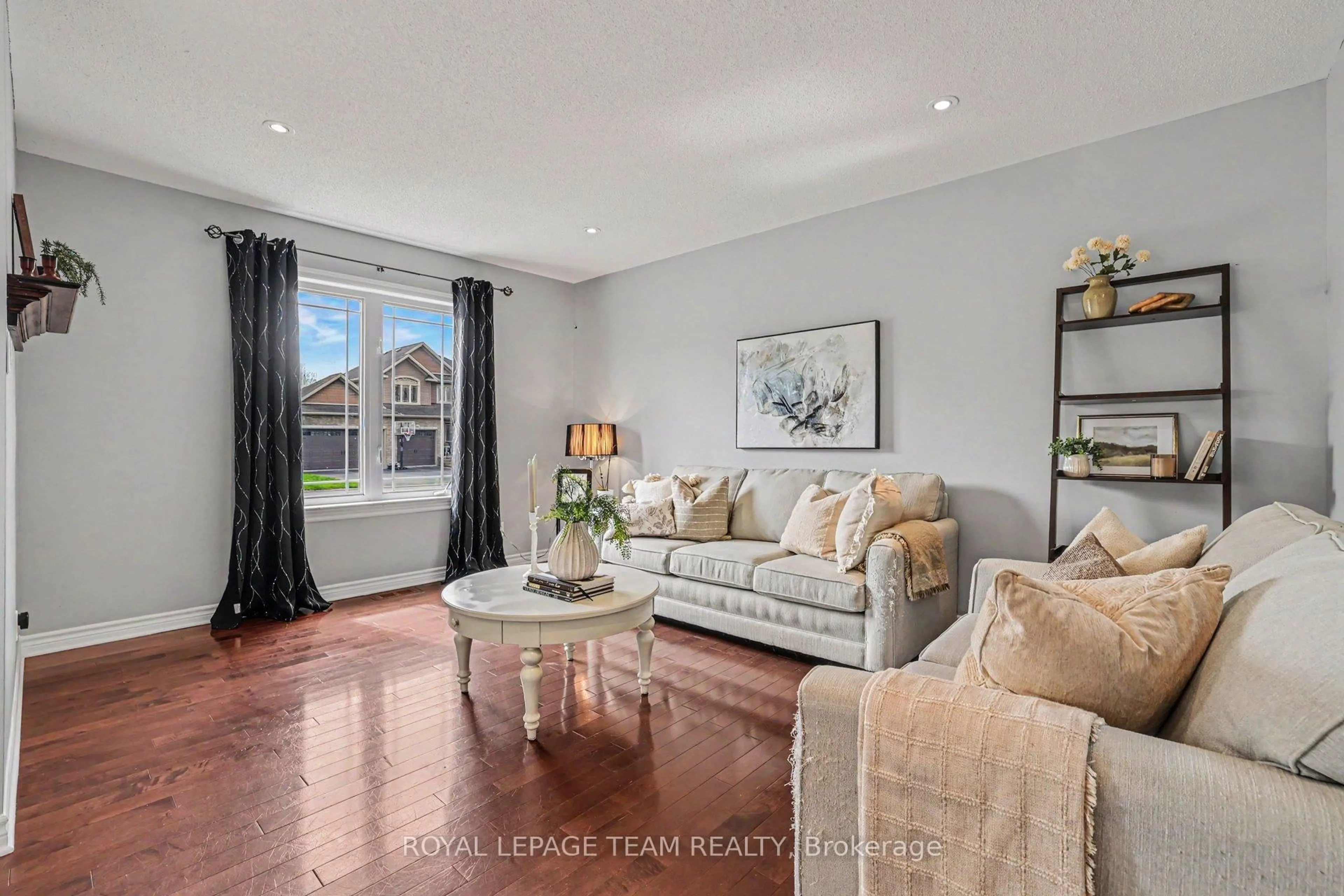 Living room with furniture, wood/laminate floor for 77 Chanonhouse Dr, Richmond Ontario K0A 2Z0