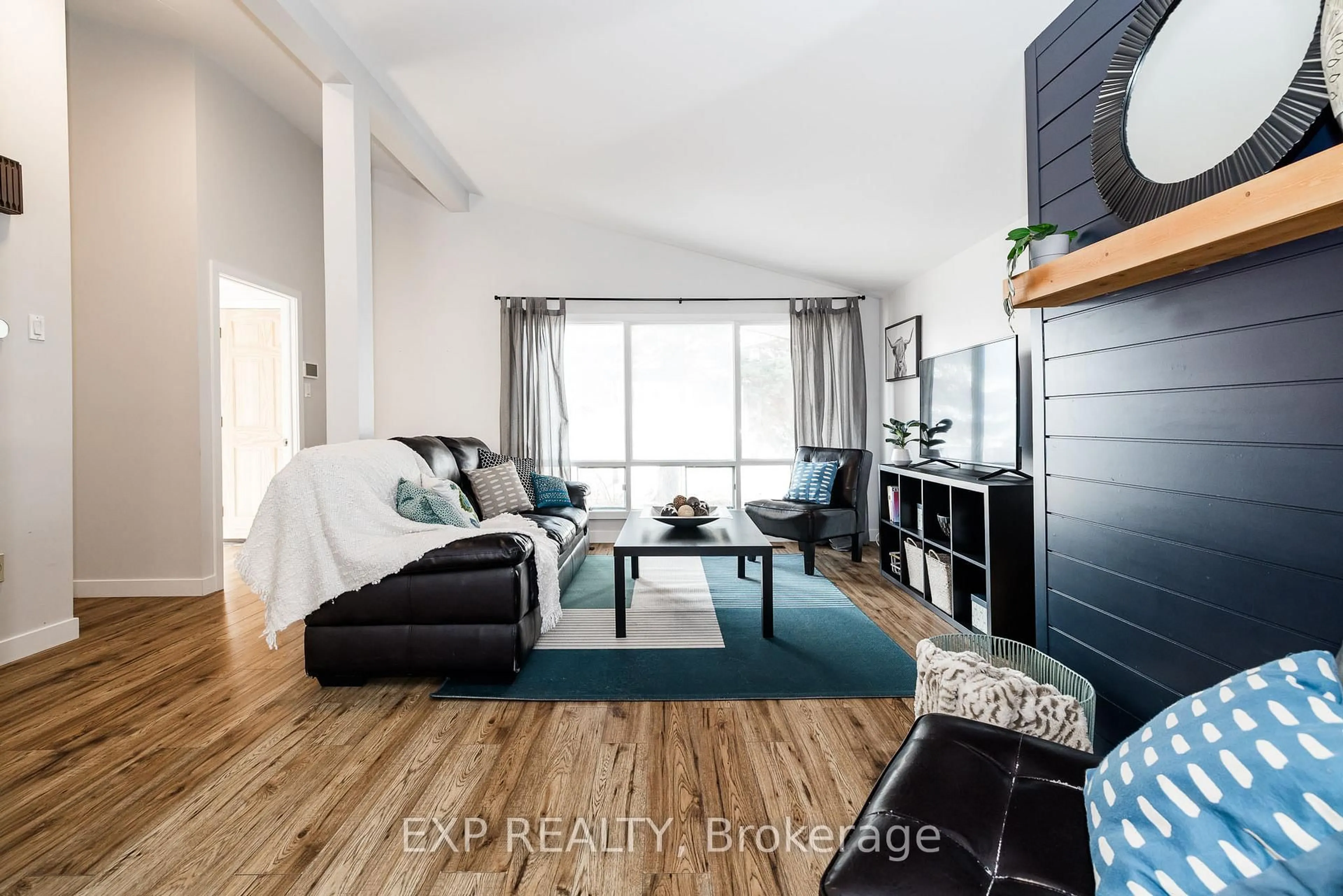 Living room with furniture, wood/laminate floor for 2196 Plesser St, Ottawa Ontario K1G 2X3