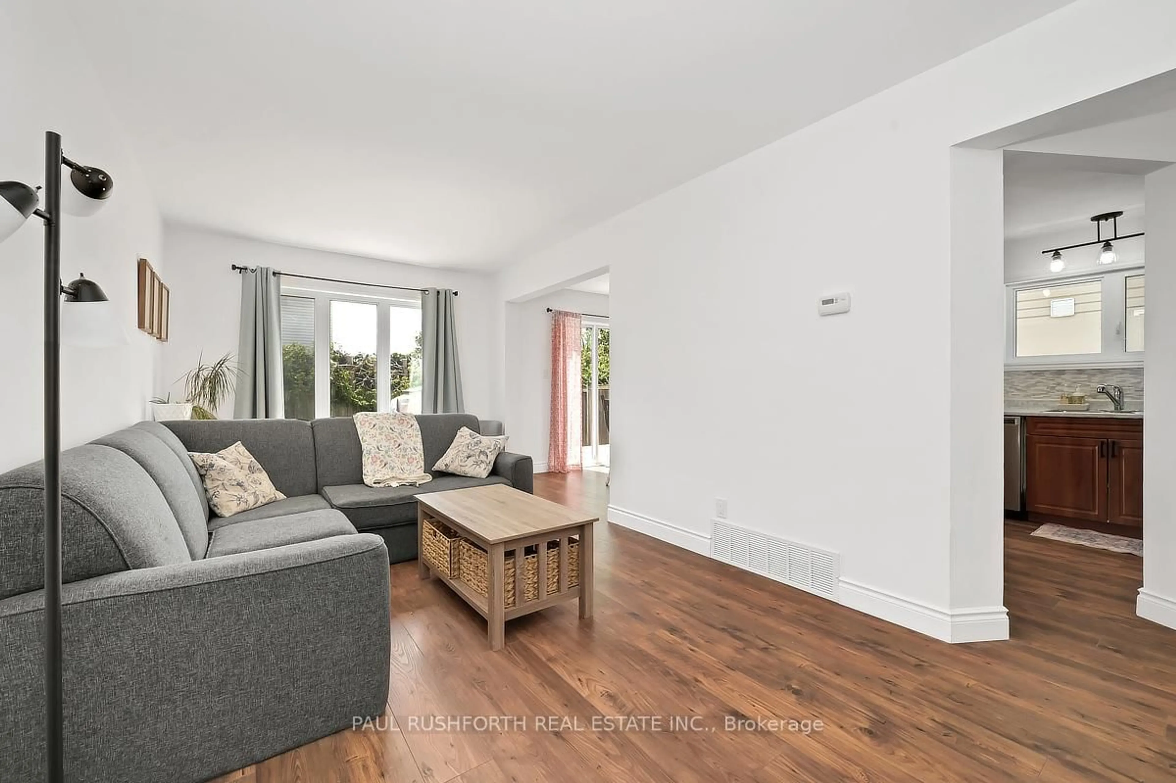 Living room with furniture, wood/laminate floor for 1476 Kamouraska Circ, Ottawa Ontario K1C 3J2