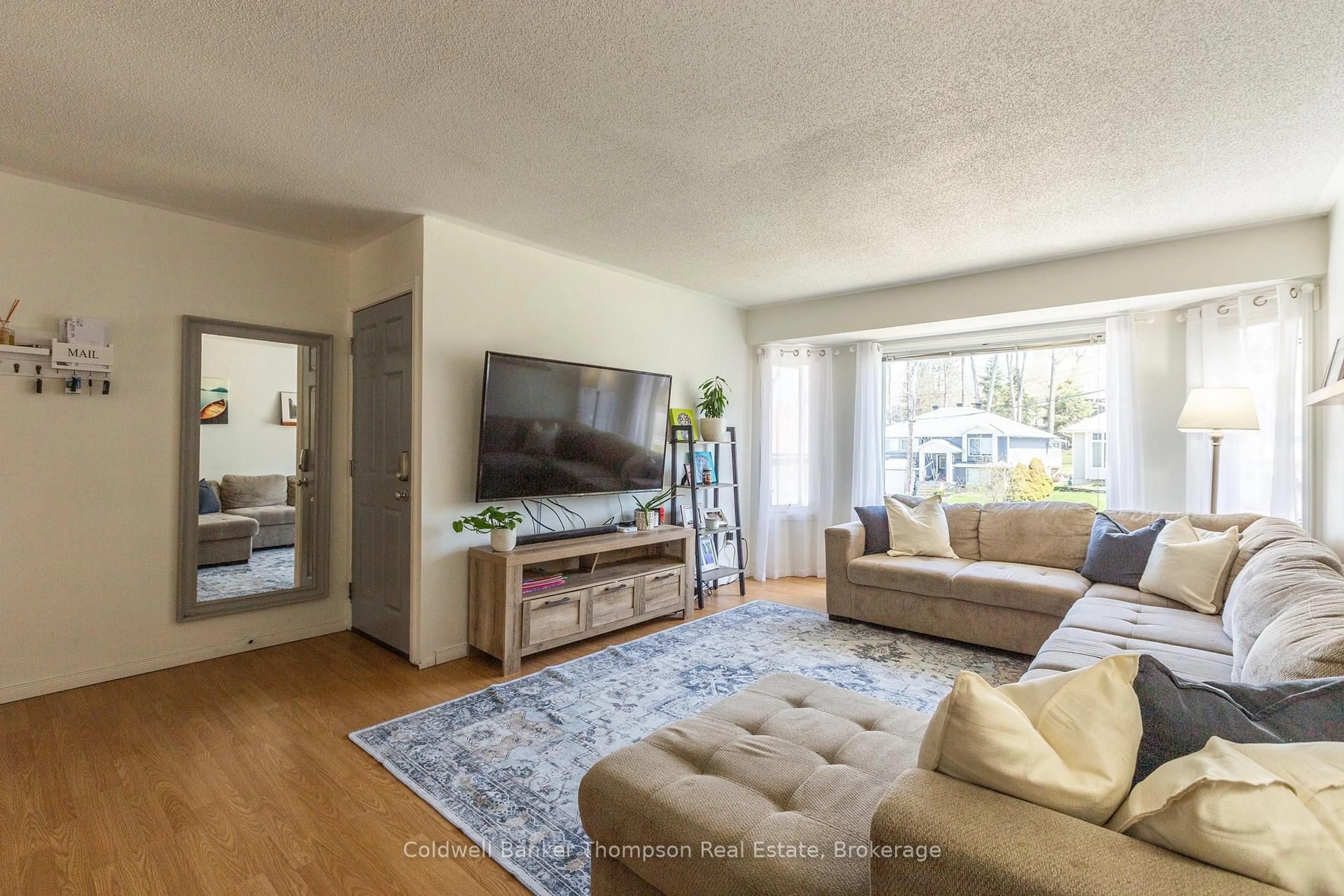 Living room with furniture, wood/laminate floor for 36 Southdale Dr, Huntsville Ontario P1H 1P7