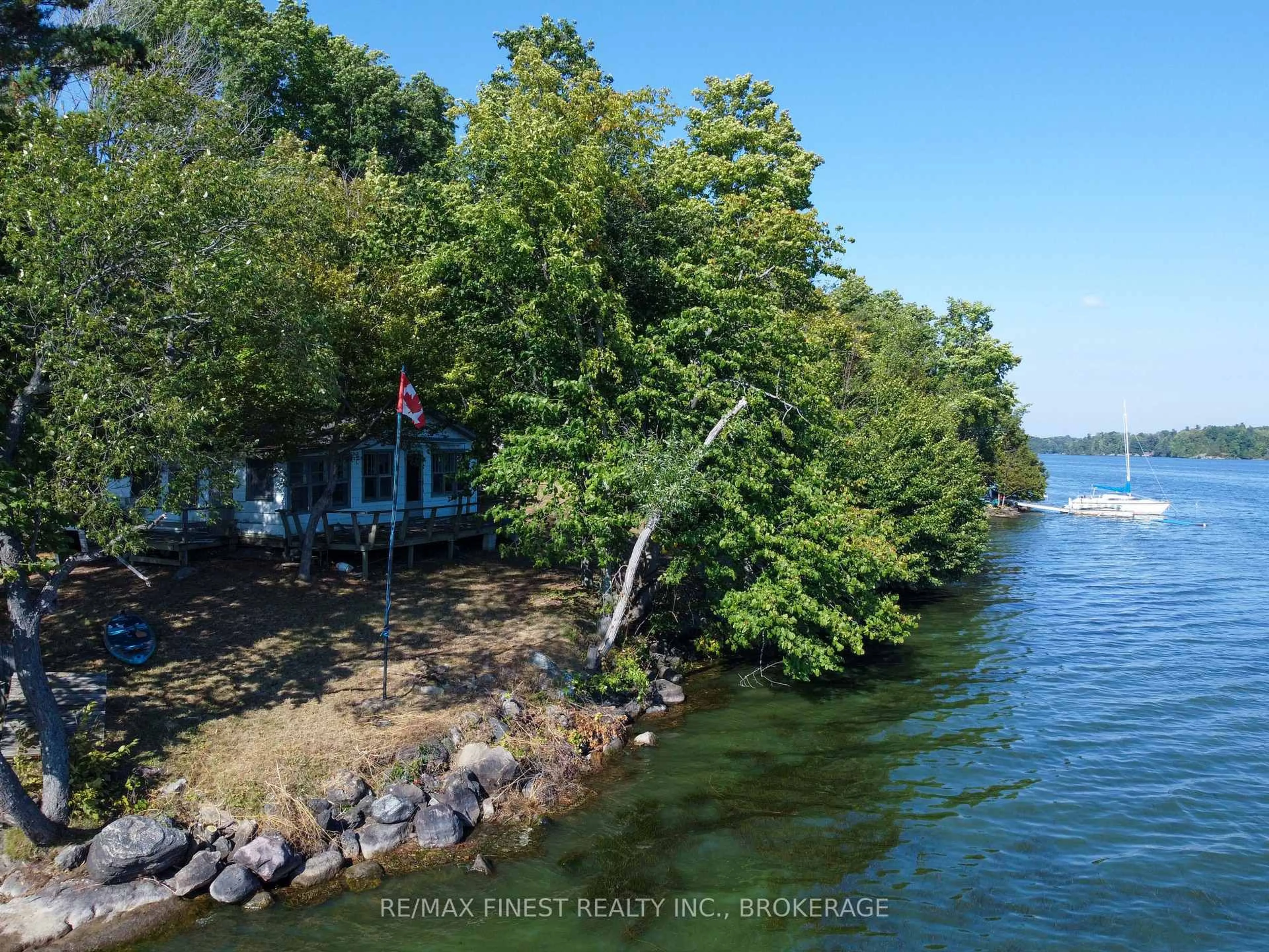 A pic from outside/outdoor area/front of a property/back of a property/a pic from drone, water/lake/river/ocean view for 4049 Hiawatha Lane, Battersea Ontario K0H 1H0