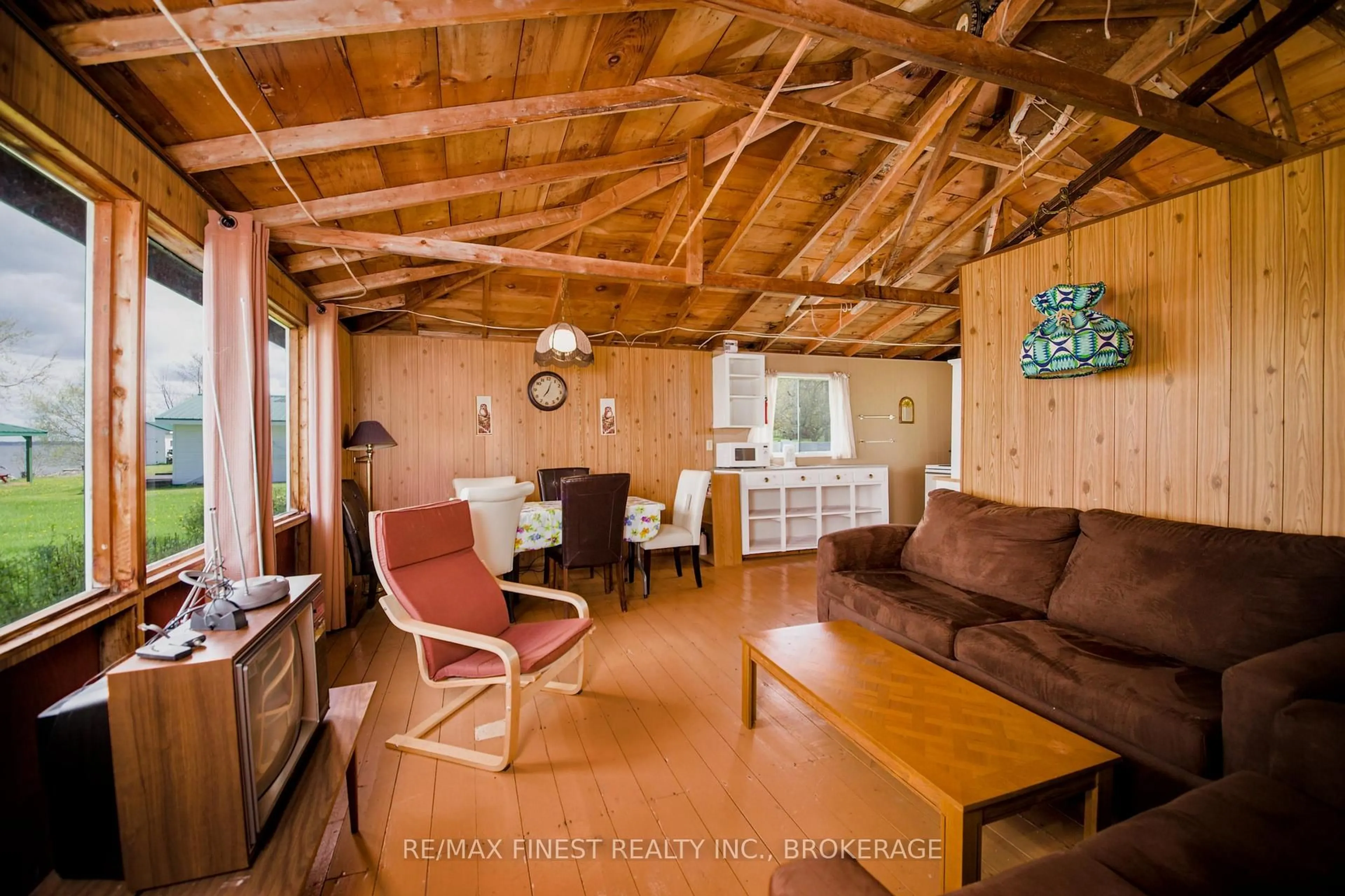 Living room with furniture, wood/laminate floor for 9300 Front Rd, Stella Ontario K0H 2S0