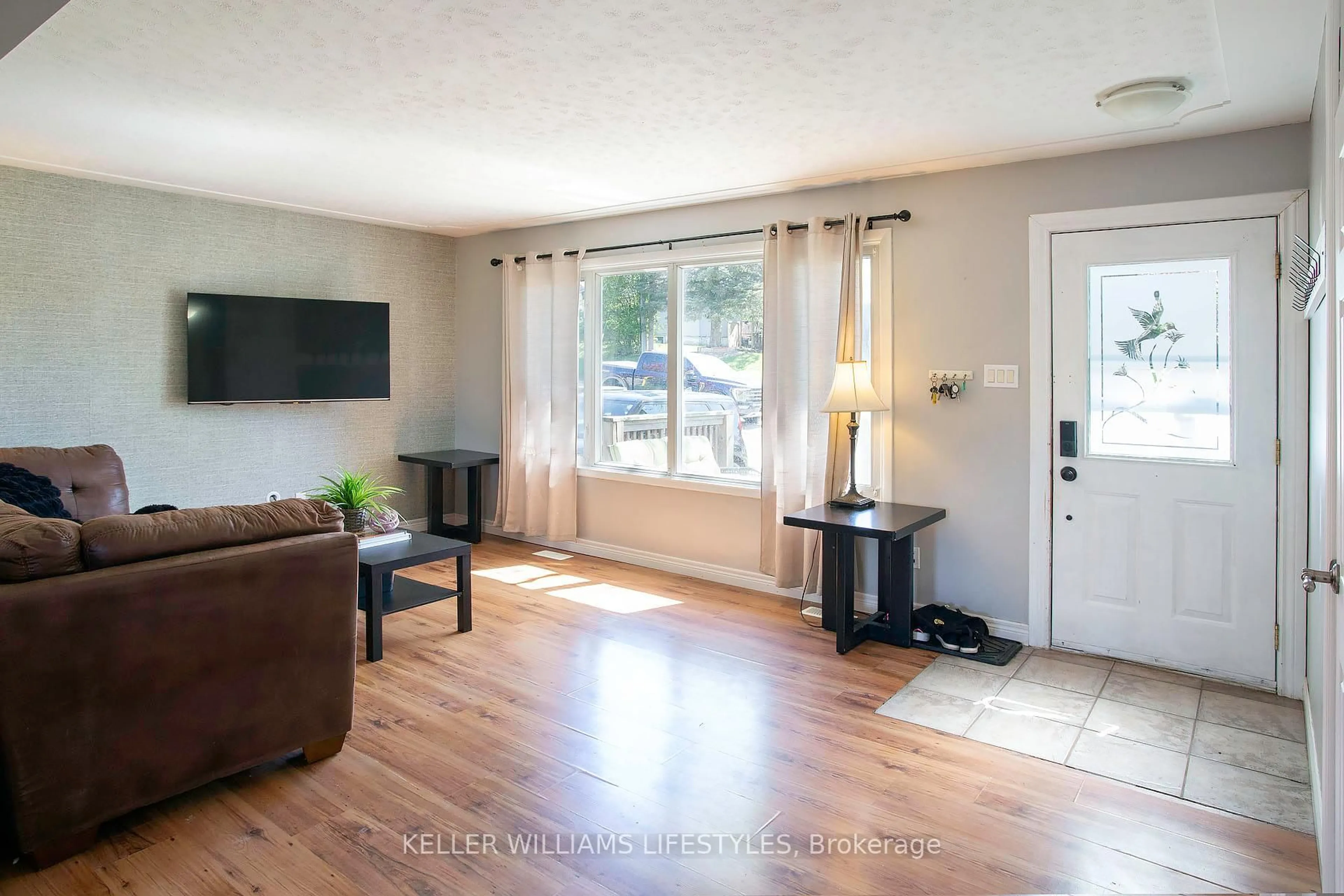 Living room with furniture, wood/laminate floor for 1043 Eagle Dr, London South Ontario N5Z 3H6