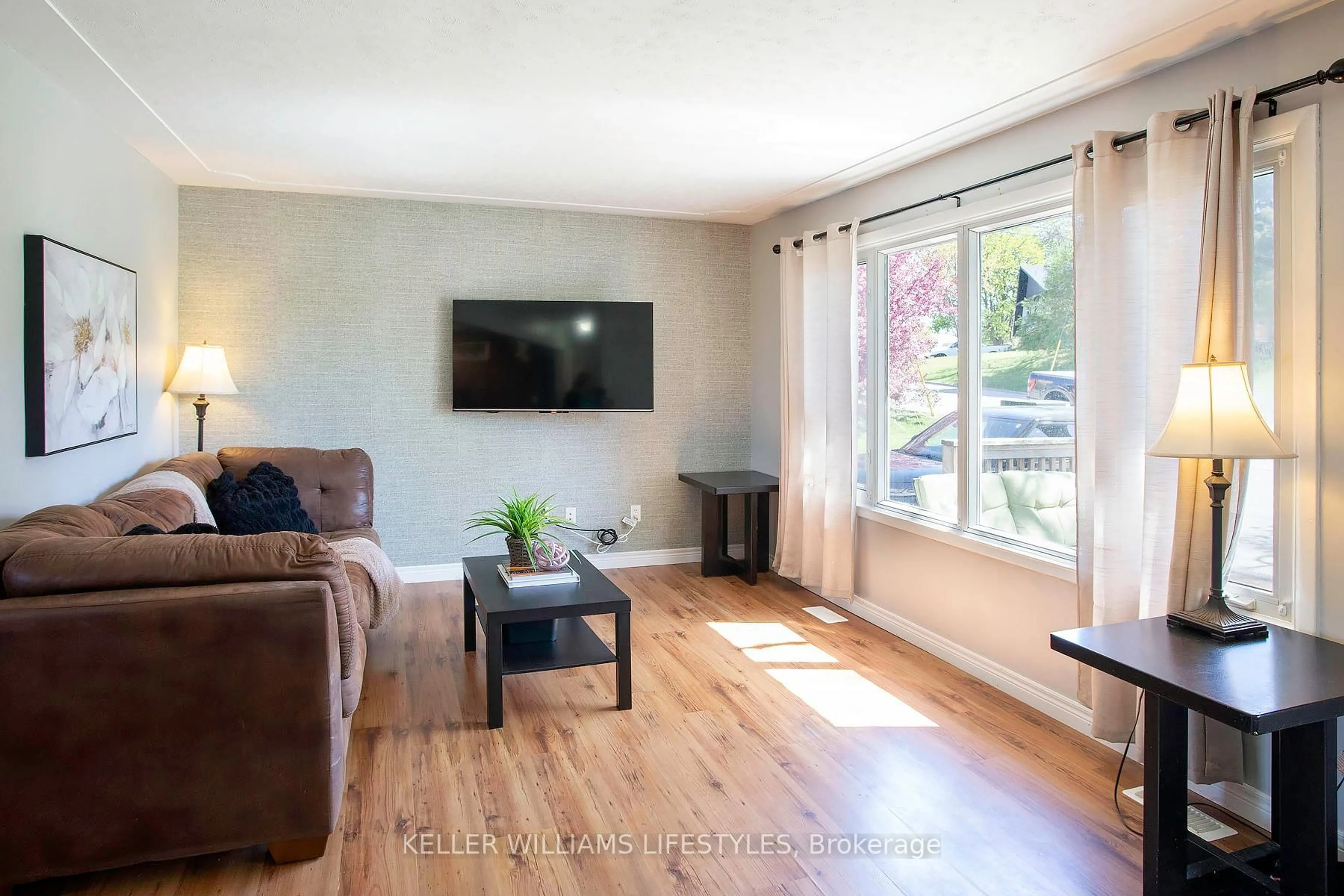 Living room with furniture, wood/laminate floor for 1043 Eagle Dr, London South Ontario N5Z 3H6