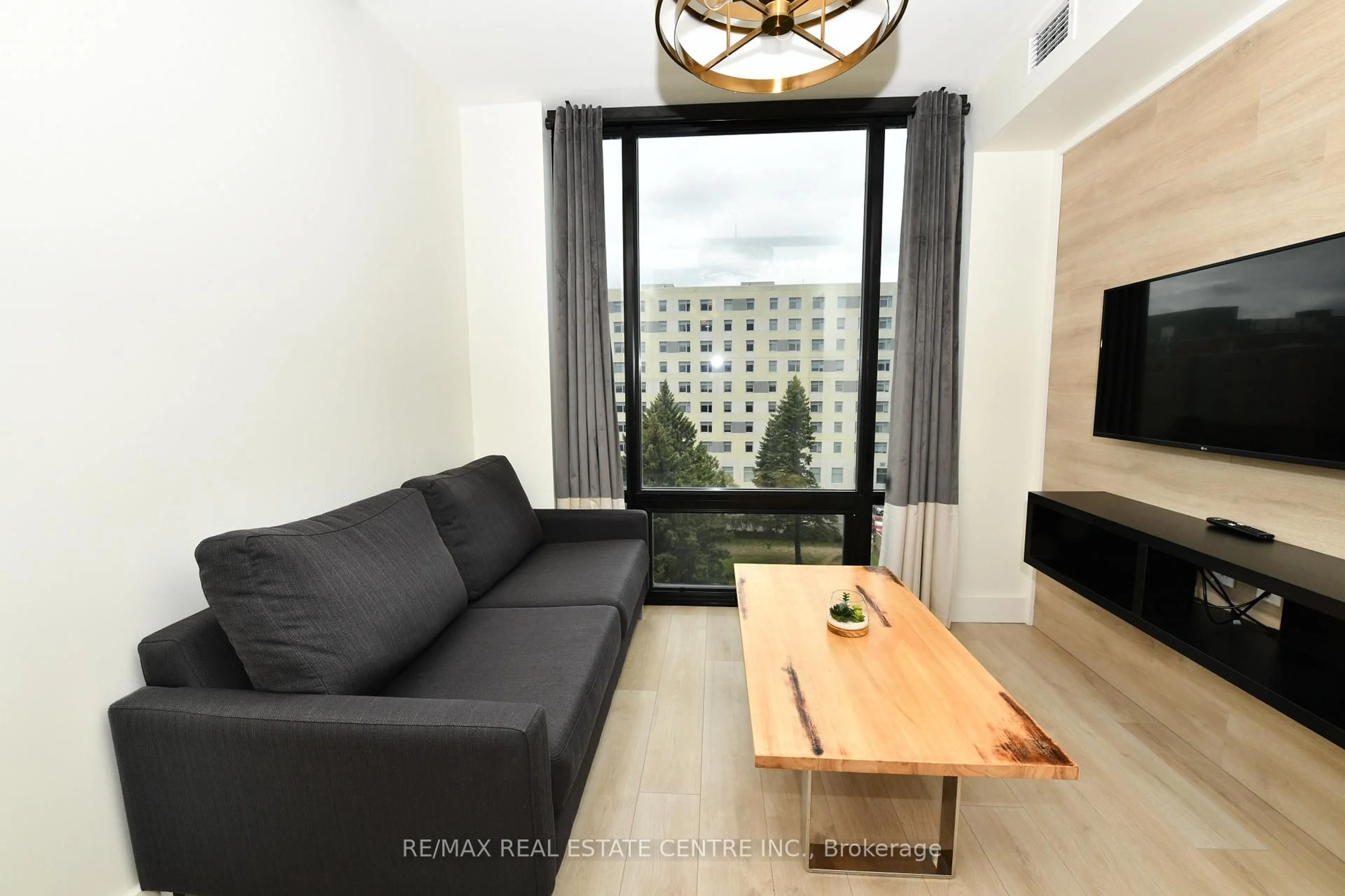 Living room with furniture, wood/laminate floor for 145 Columbia St #736, Waterloo Ontario N2L 3L2