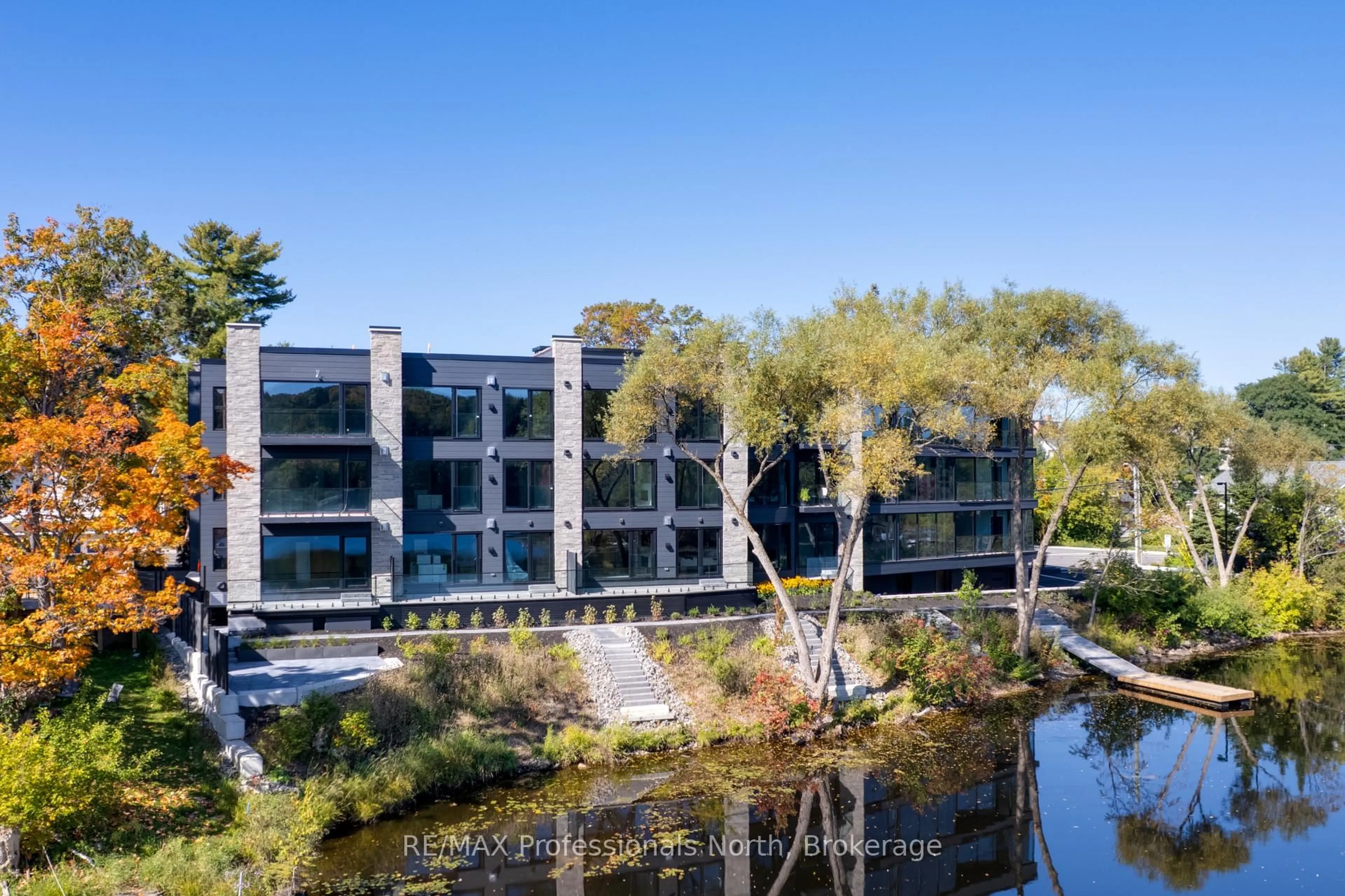A pic from outside/outdoor area/front of a property/back of a property/a pic from drone, water/lake/river/ocean view for 32 Brunel Rd #105, Huntsville Ontario P1H 1P5