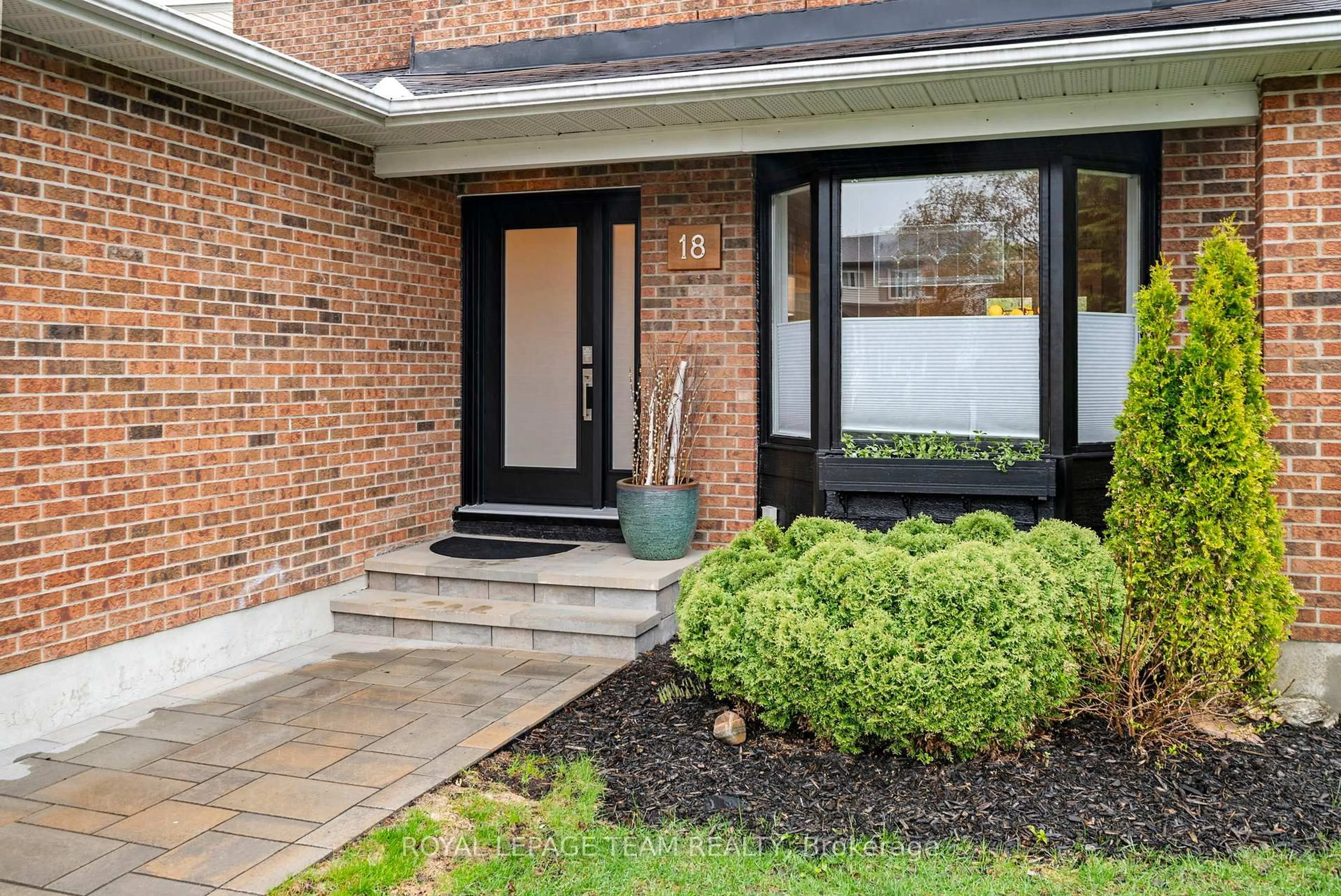 Home with brick exterior material, street for 18 Valley Ridge St, Ottawa Ontario K2E 7V9