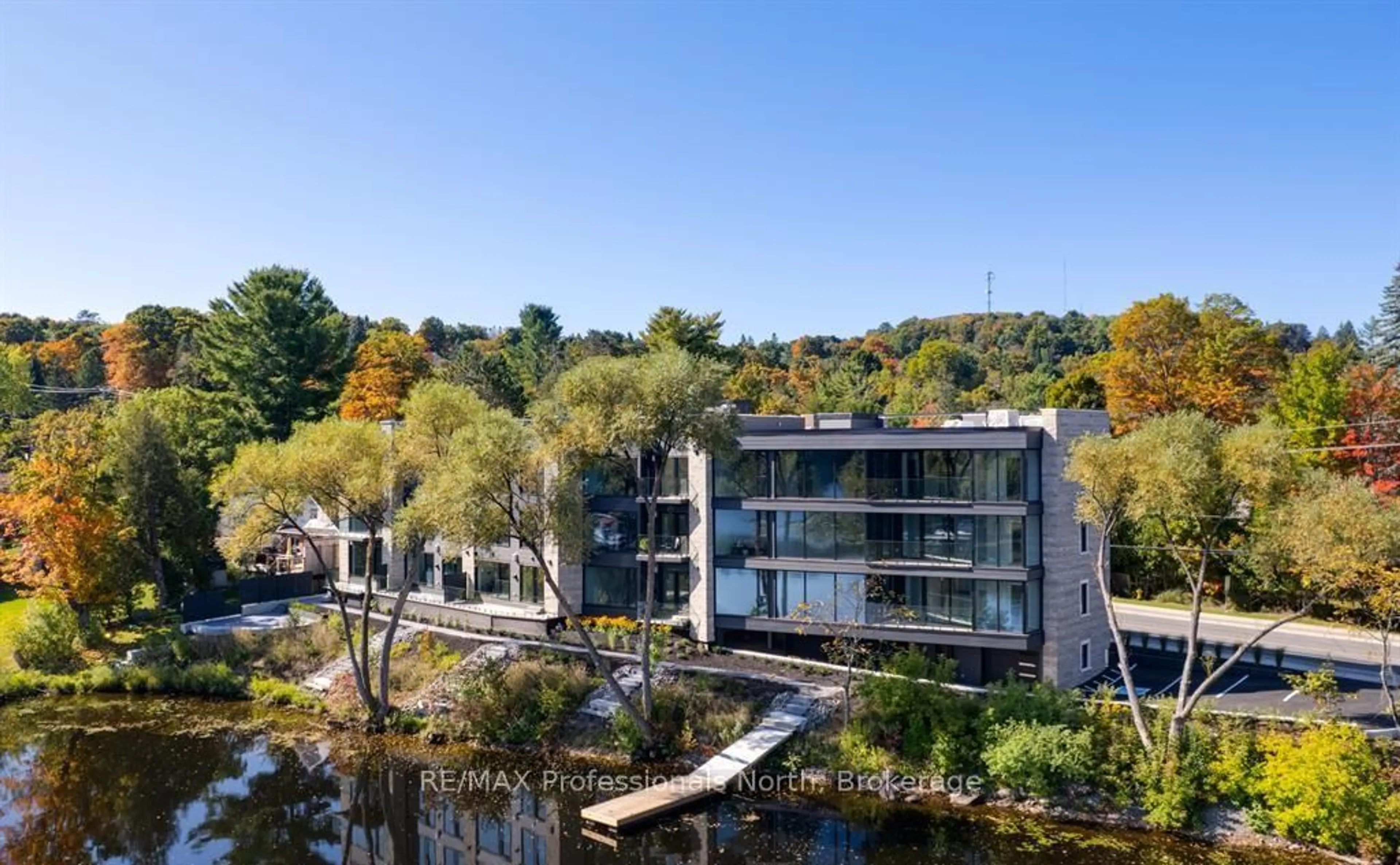 A pic from outside/outdoor area/front of a property/back of a property/a pic from drone, water/lake/river/ocean view for 32 Brunel Rd #102, Huntsville Ontario P1H 1P5