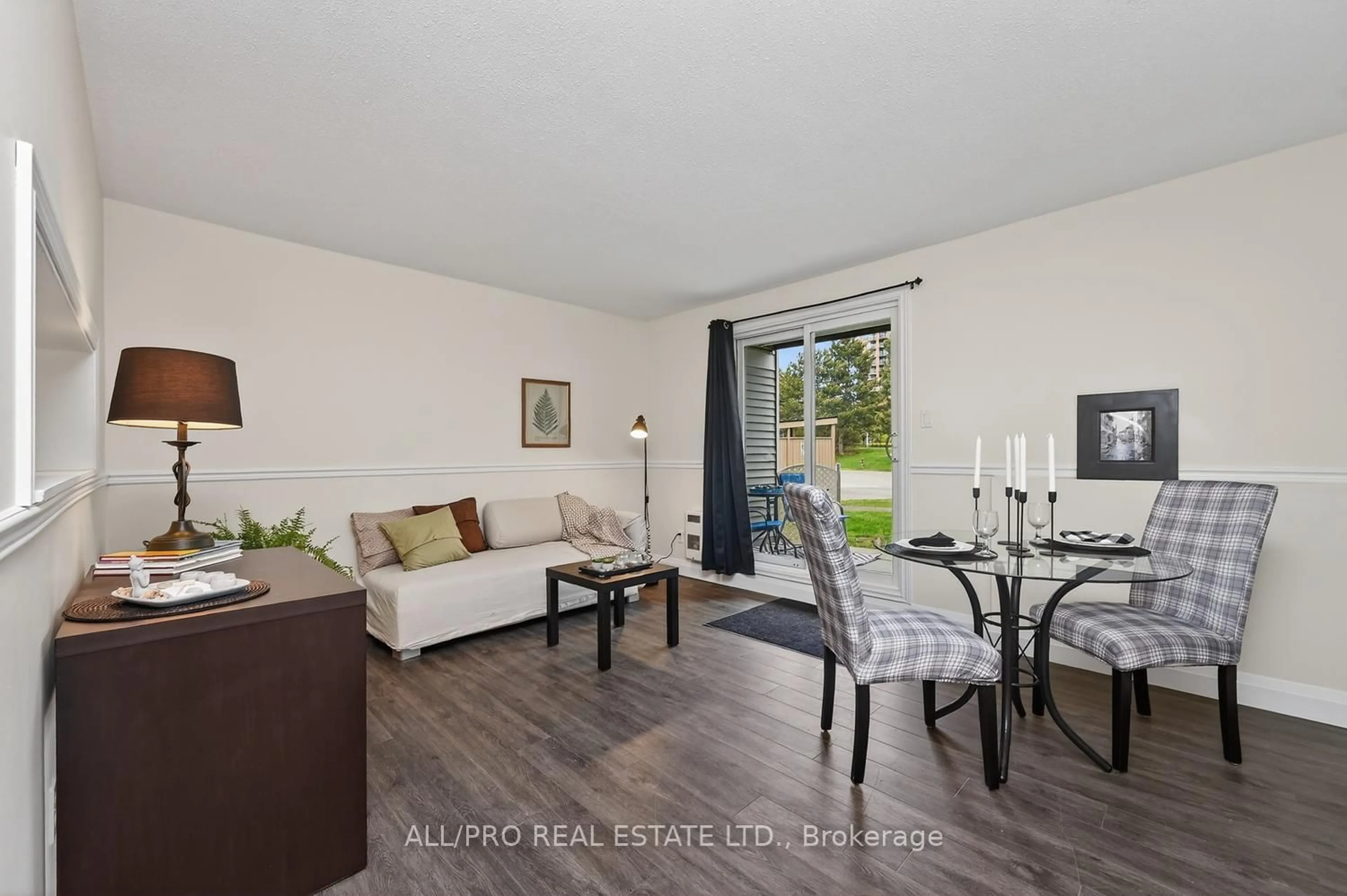 Living room with furniture, wood/laminate floor for 212 Viewmount Dr #111, Ottawa Ontario K2E 7X2