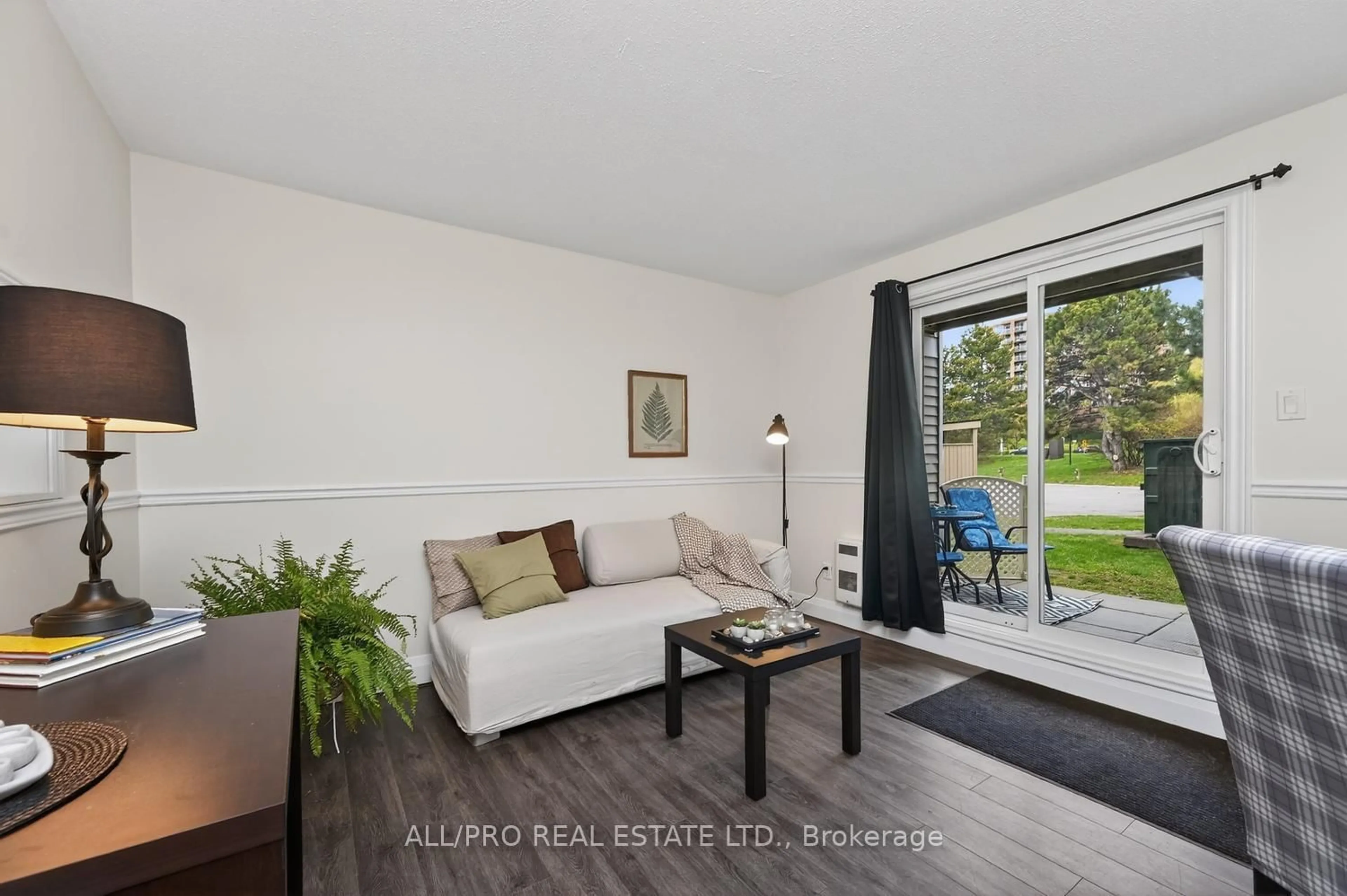 Living room with furniture, wood/laminate floor for 212 Viewmount Dr #111, Ottawa Ontario K2E 7X2
