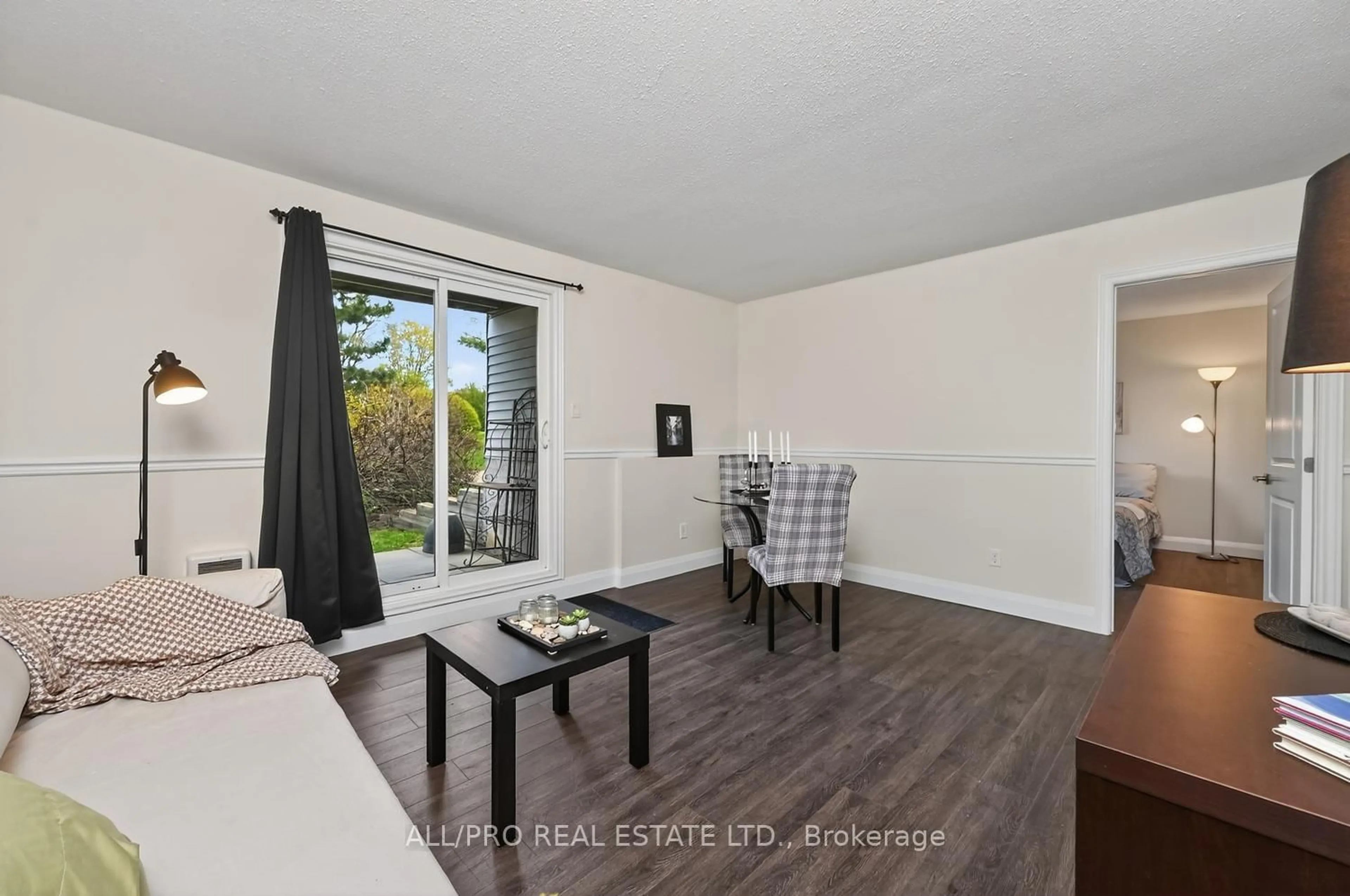 Living room with furniture, wood/laminate floor for 212 Viewmount Dr #111, Ottawa Ontario K2E 7X2