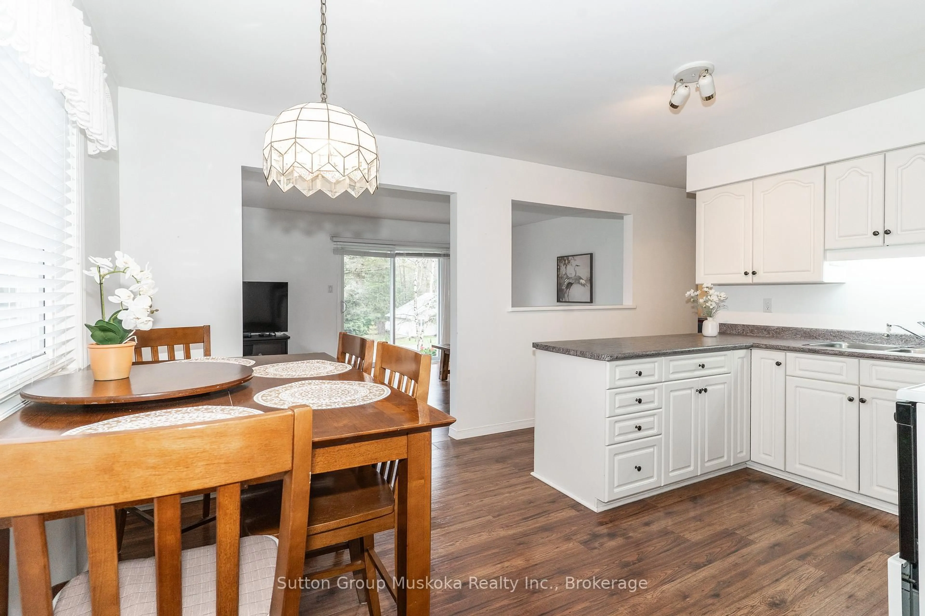 Open concept kitchen, wood/laminate floor for 64 Spruce Dr, Huntsville Ontario P0B 1L0