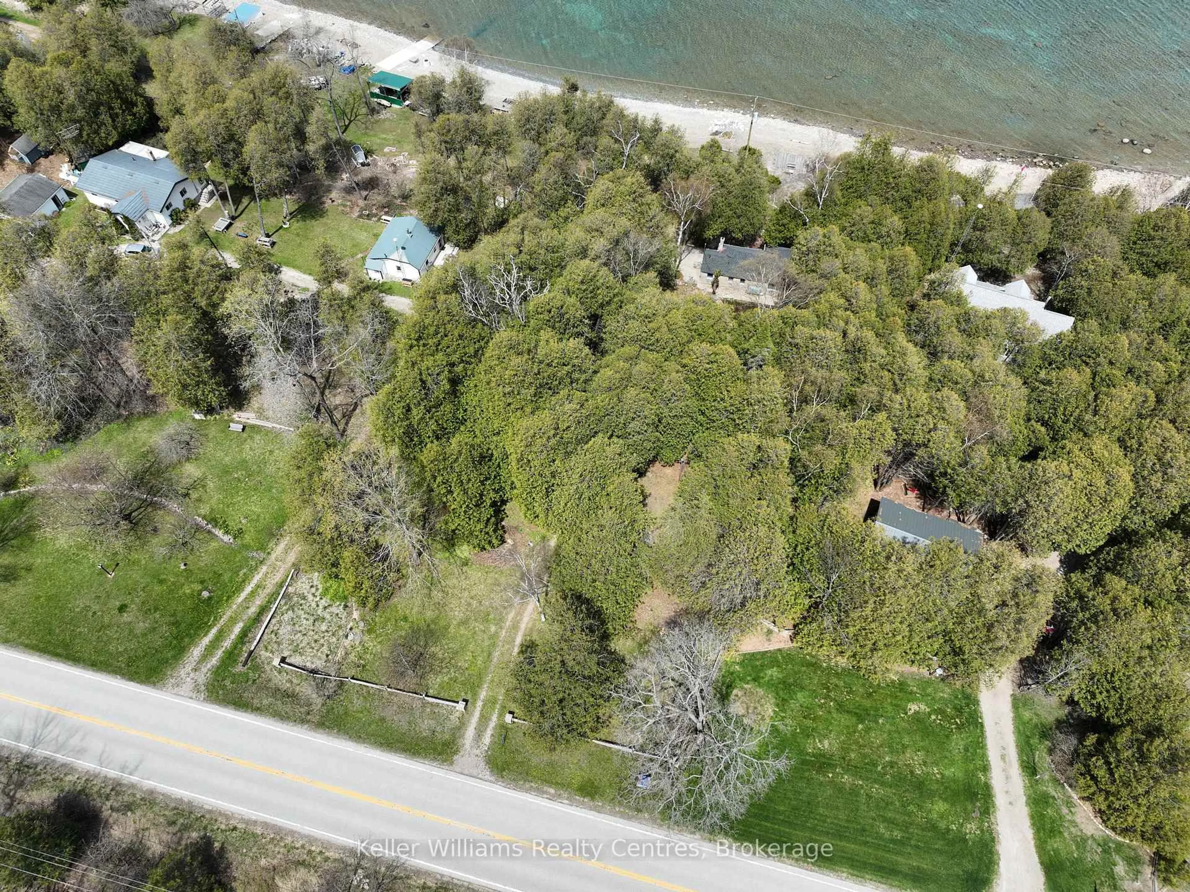 A pic from outside/outdoor area/front of a property/back of a property/a pic from drone, water/lake/river/ocean view for 504215 Grey Road 1, Georgian Bluffs Ontario N0H 2T0