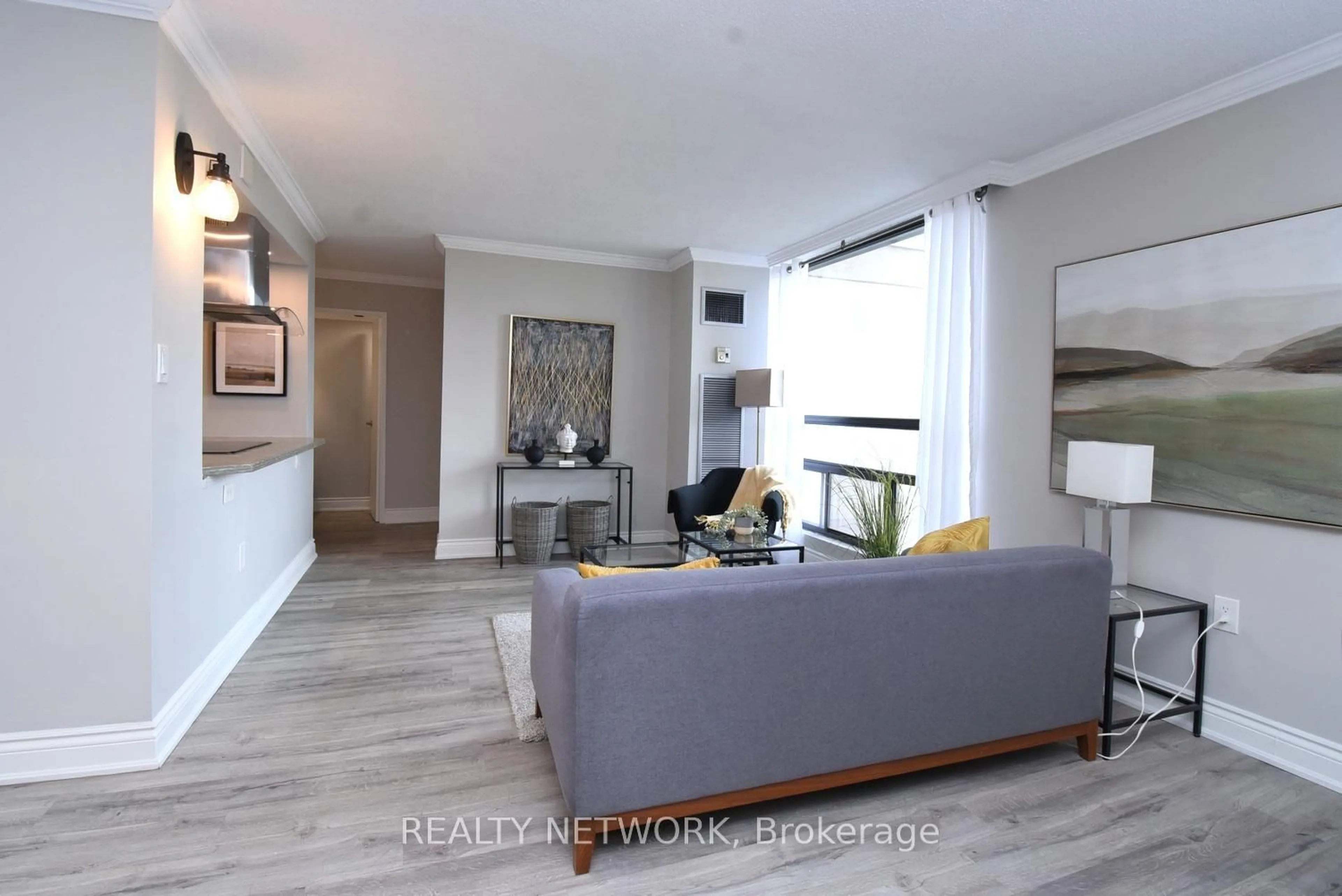 Living room with furniture, wood/laminate floor for 222 Jackson St #702, Hamilton Ontario L8P 4S5