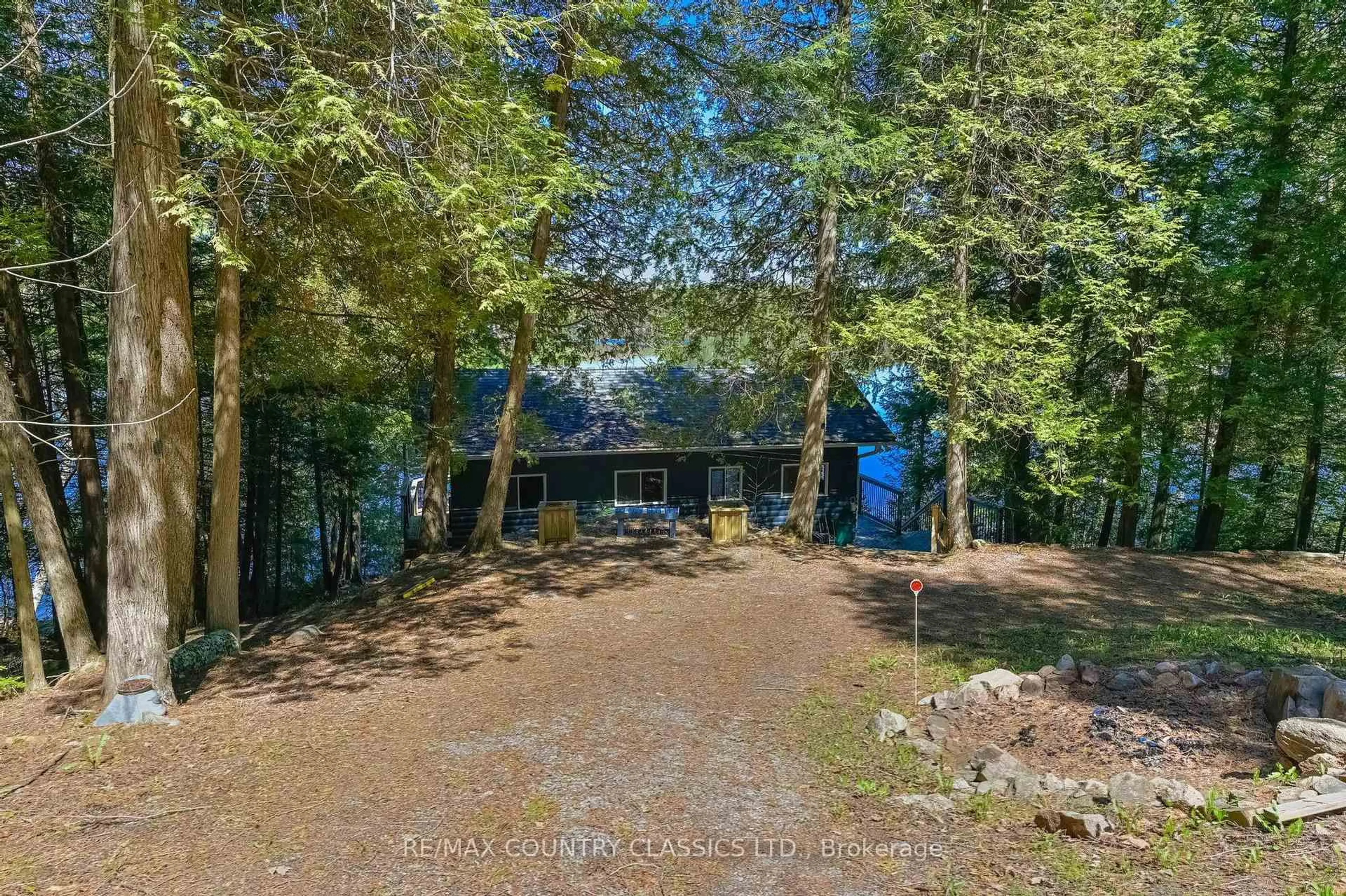 A pic from outside/outdoor area/front of a property/back of a property/a pic from drone, forest/trees view for 204 Blue Heron Lane, North Kawartha Ontario K0L 1A0