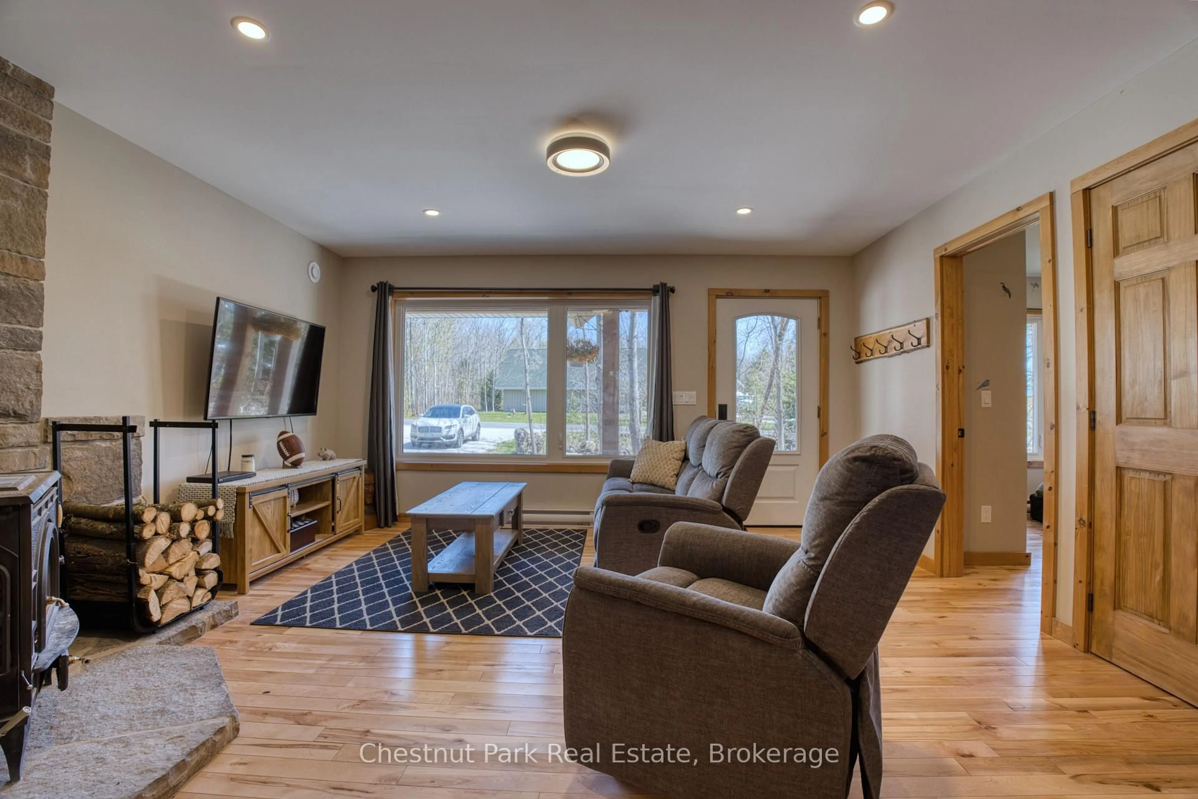 Living room with furniture, wood/laminate floor for 23 Maple Dr, Northern Bruce Peninsula Ontario N0H 1Z0