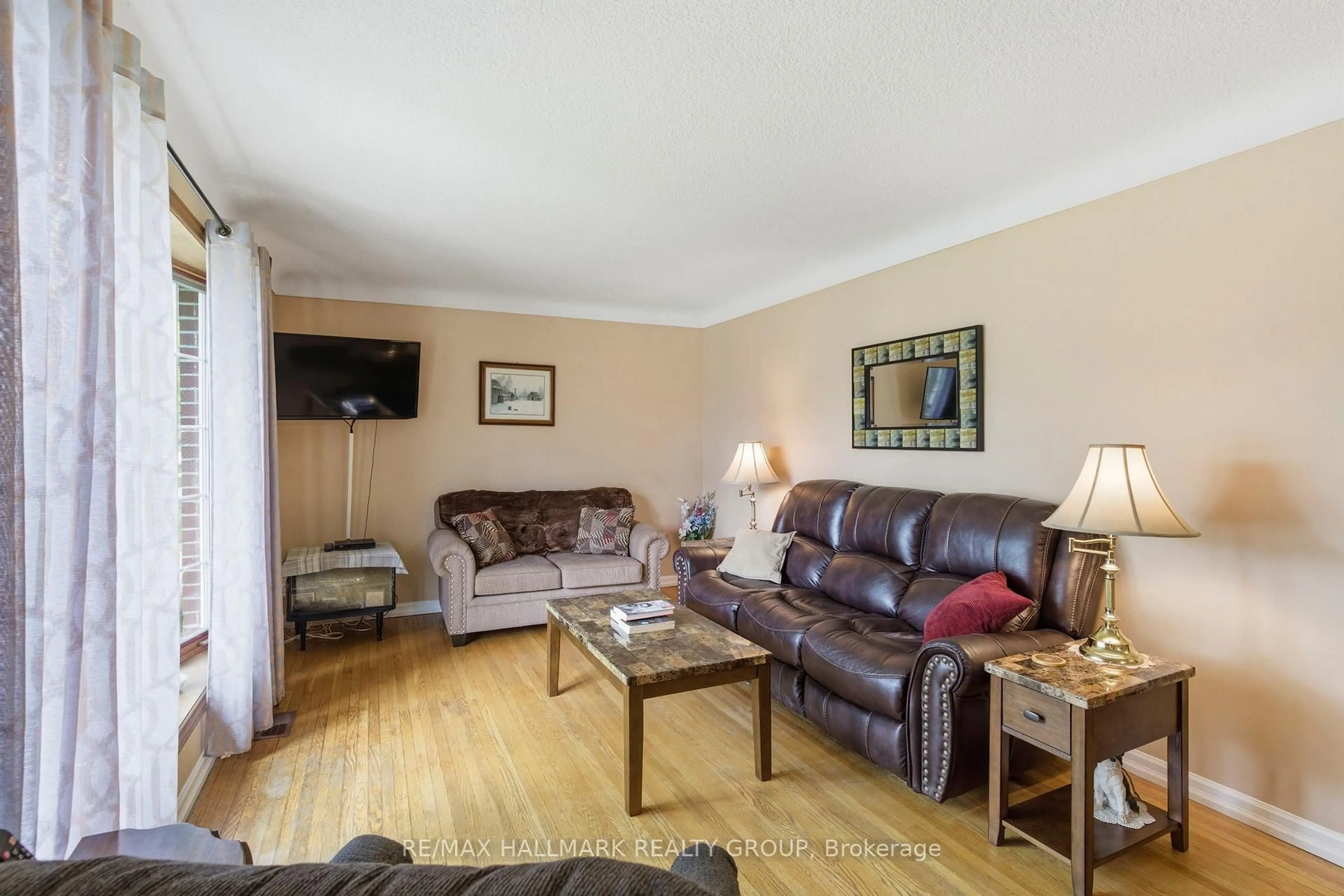 Living room with furniture, wood/laminate floor for 23 Aldershot Ave, Brockville Ontario K6V 2P7