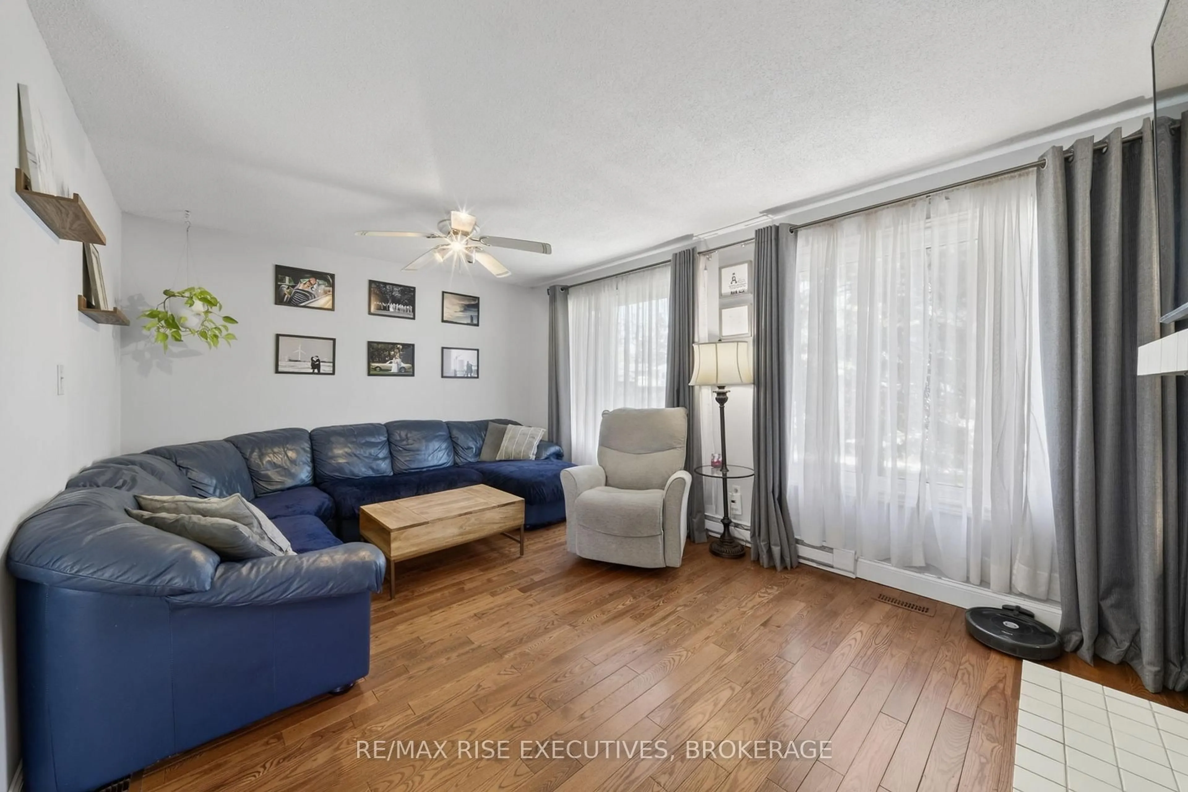 Living room with furniture, wood/laminate floor for 1089 Pinewood Pl, Kingston Ontario K7P 1K9