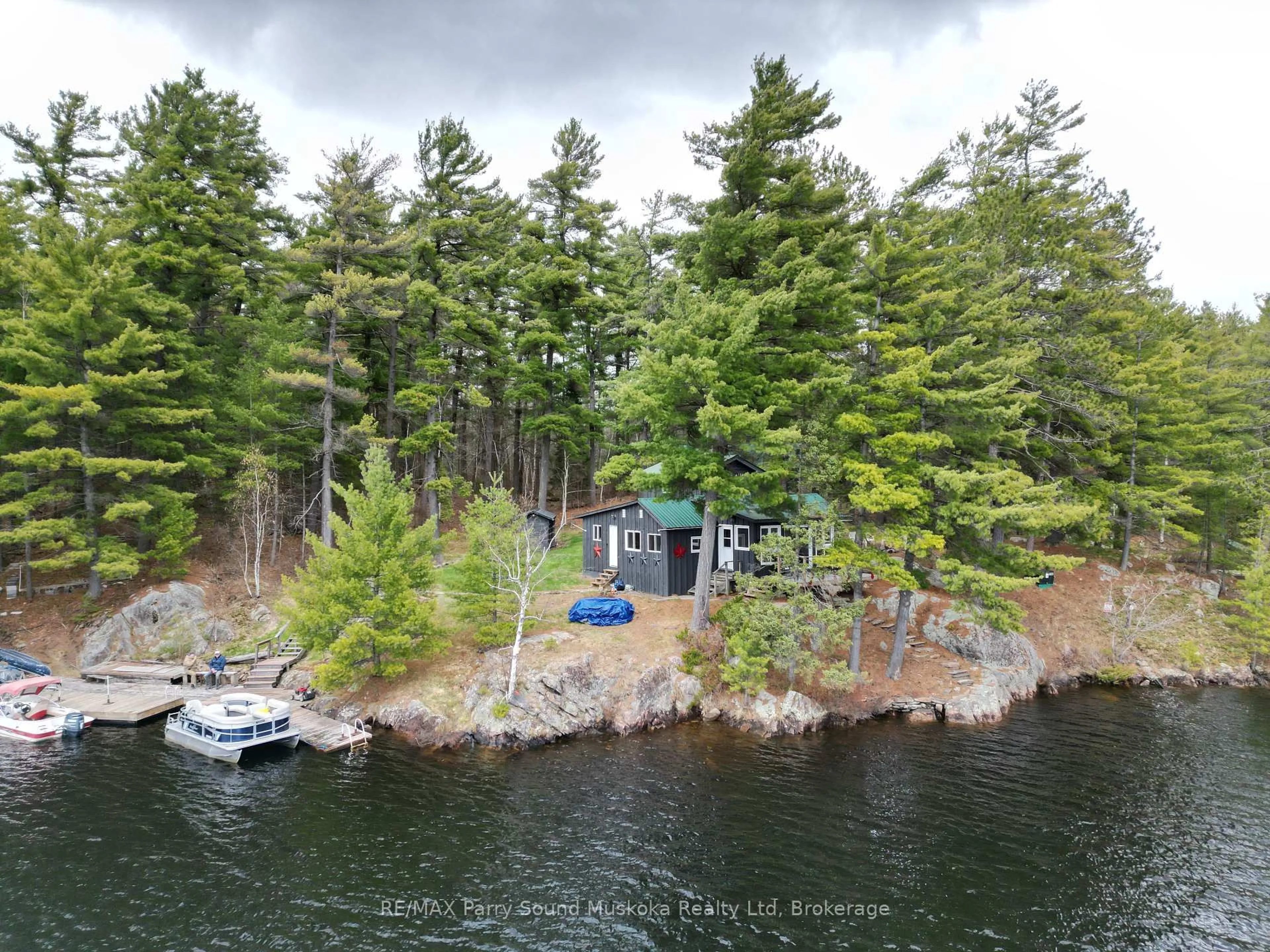 A pic from outside/outdoor area/front of a property/back of a property/a pic from drone, water/lake/river/ocean view for 104 Kawigamog Lake, Parry Sound Remote Area Ontario P0H 1S0