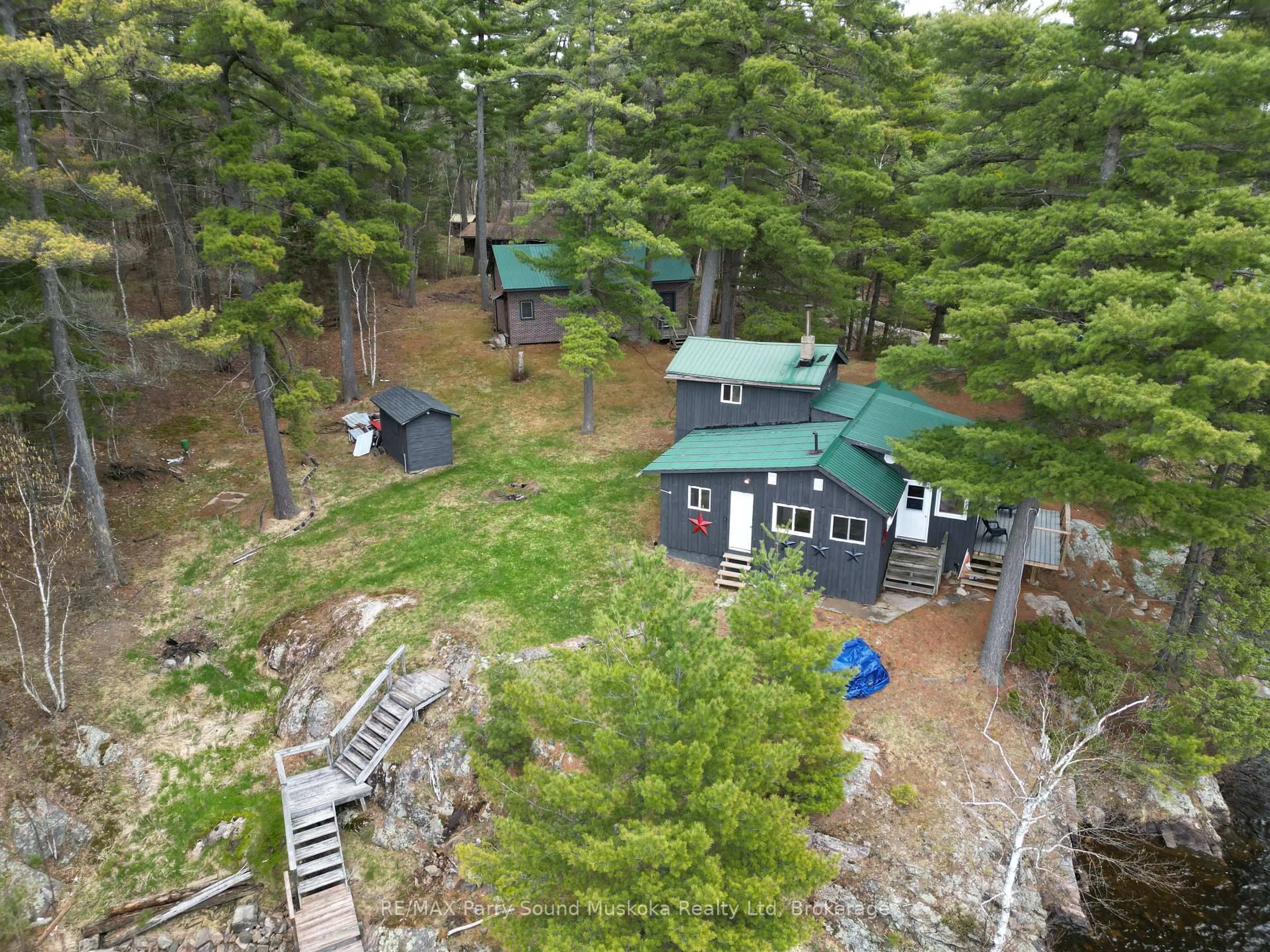 A pic from outside/outdoor area/front of a property/back of a property/a pic from drone, forest/trees view for 104 Kawigamog Lake, Parry Sound Remote Area Ontario P0H 1S0
