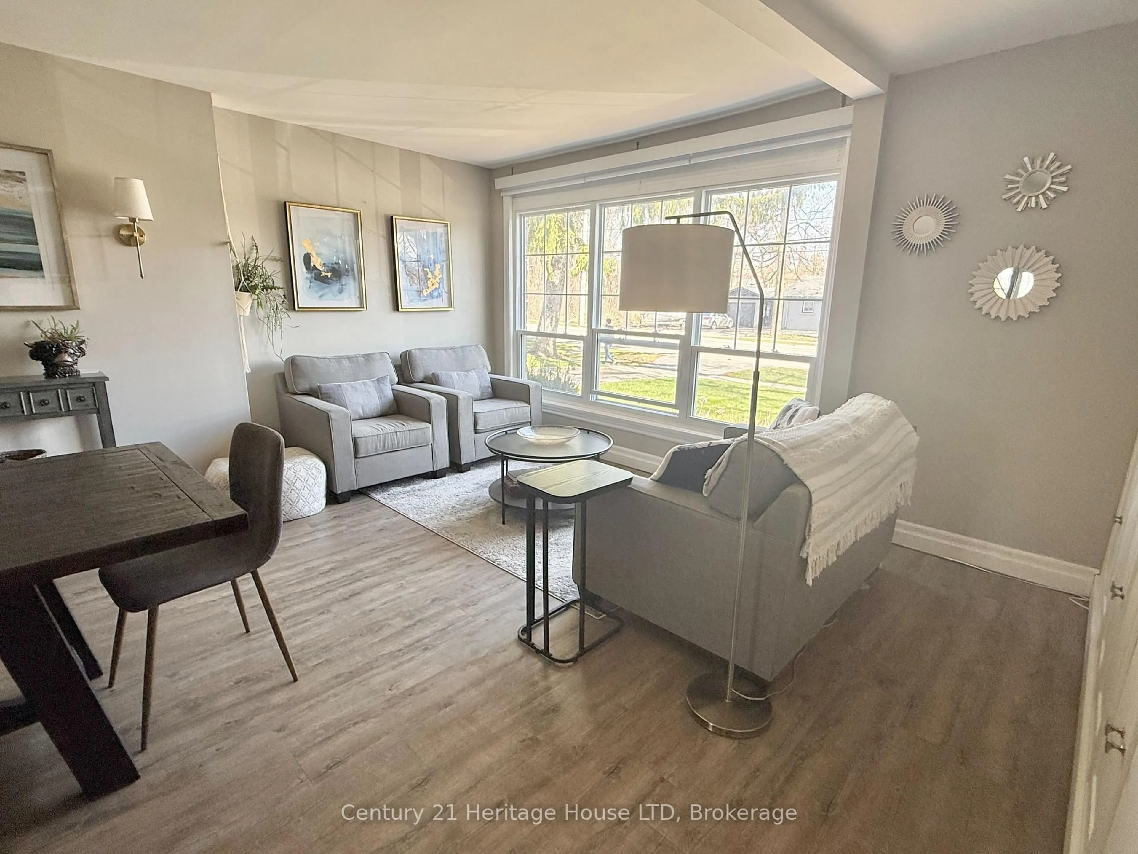 Living room with furniture, wood/laminate floor for 6021 Montrose Rd, Niagara Falls Ontario L2H 1L4
