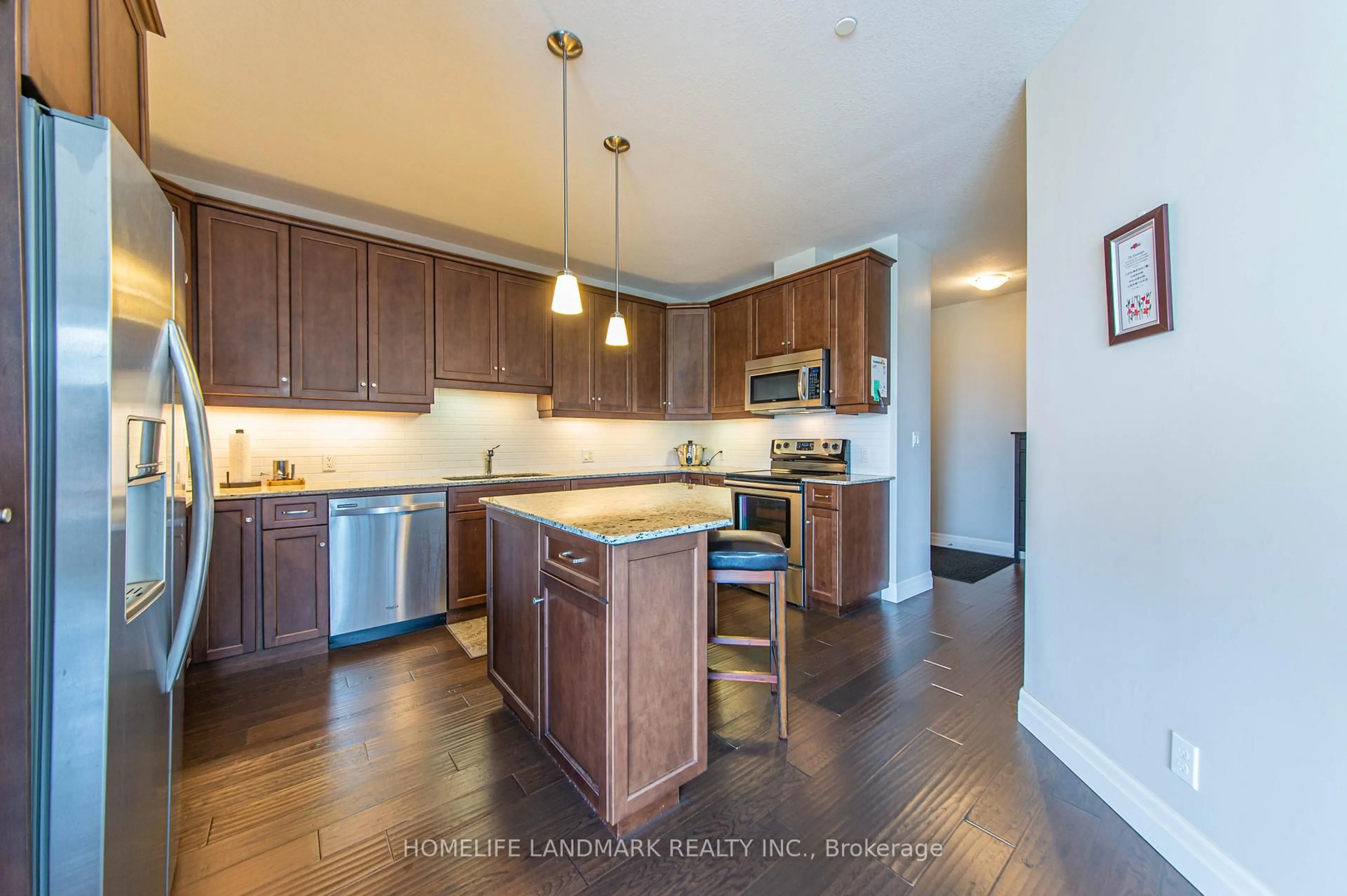 Open concept kitchen, wood/laminate floor for 223 Erb St #302, Waterloo Ontario N2L 0B3