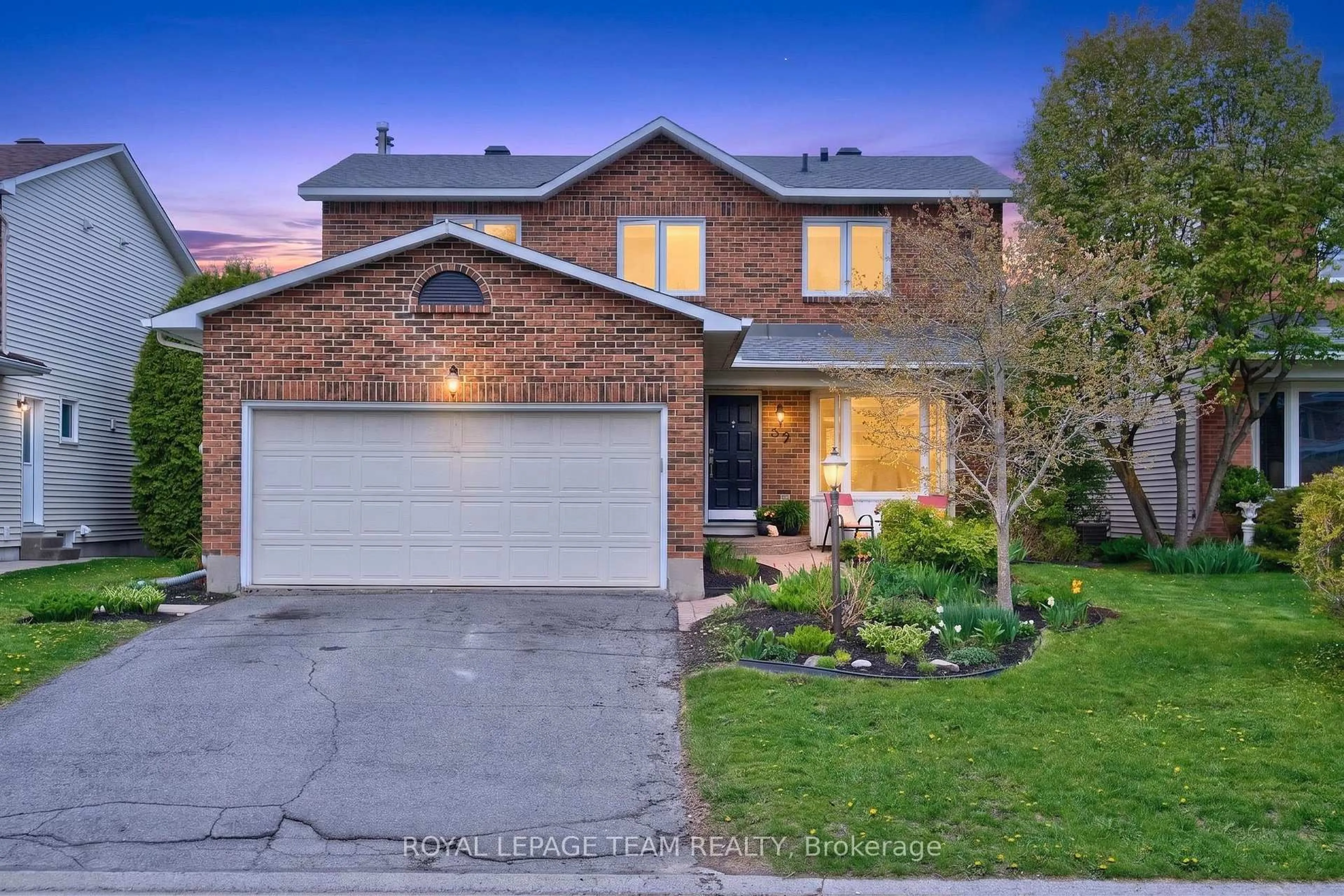 Home with brick exterior material, street for 52 Drainie Dr, Kanata Ontario K2L 3J9