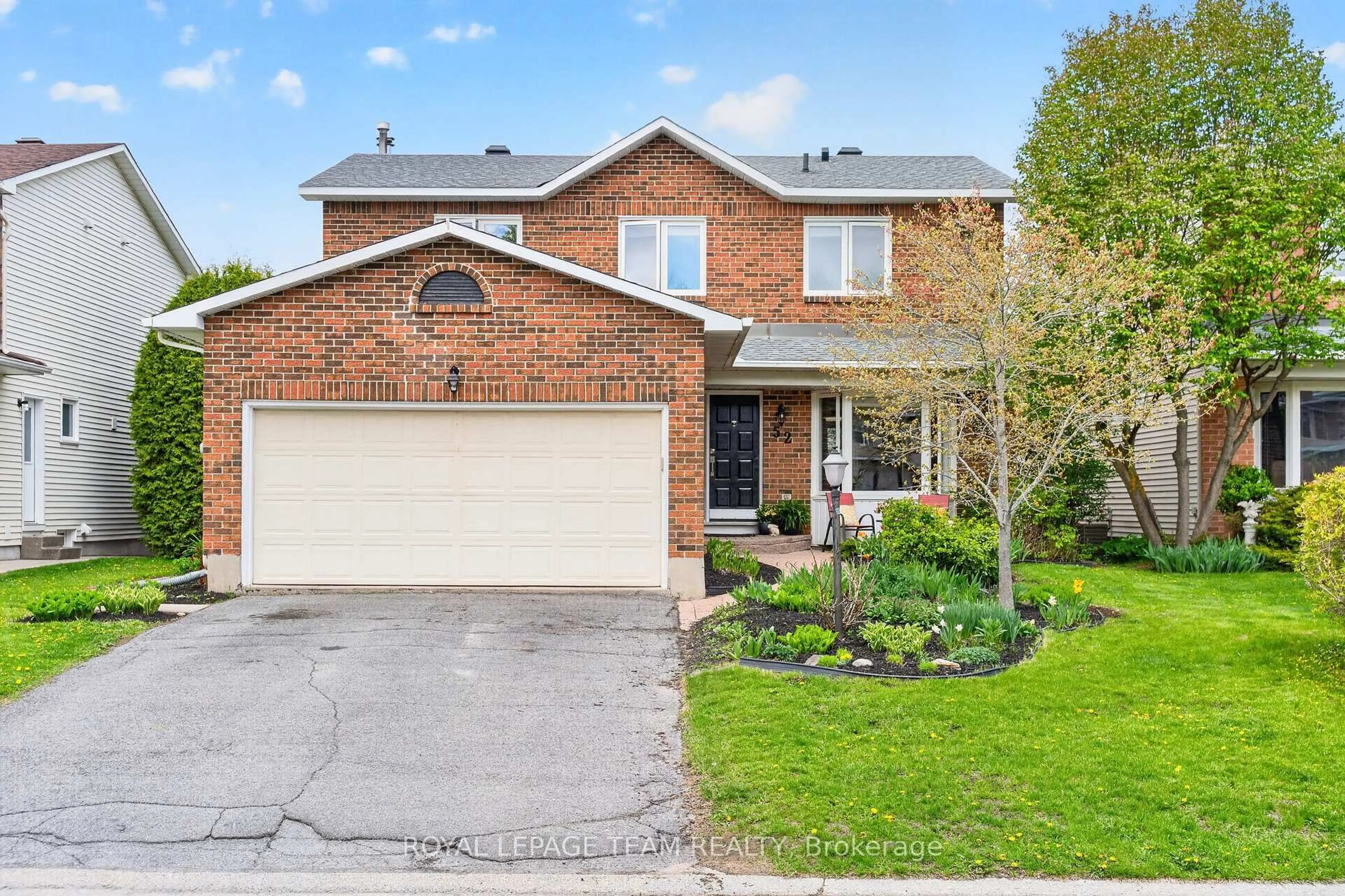 Home with brick exterior material, street for 52 Drainie Dr, Kanata Ontario K2L 3J9