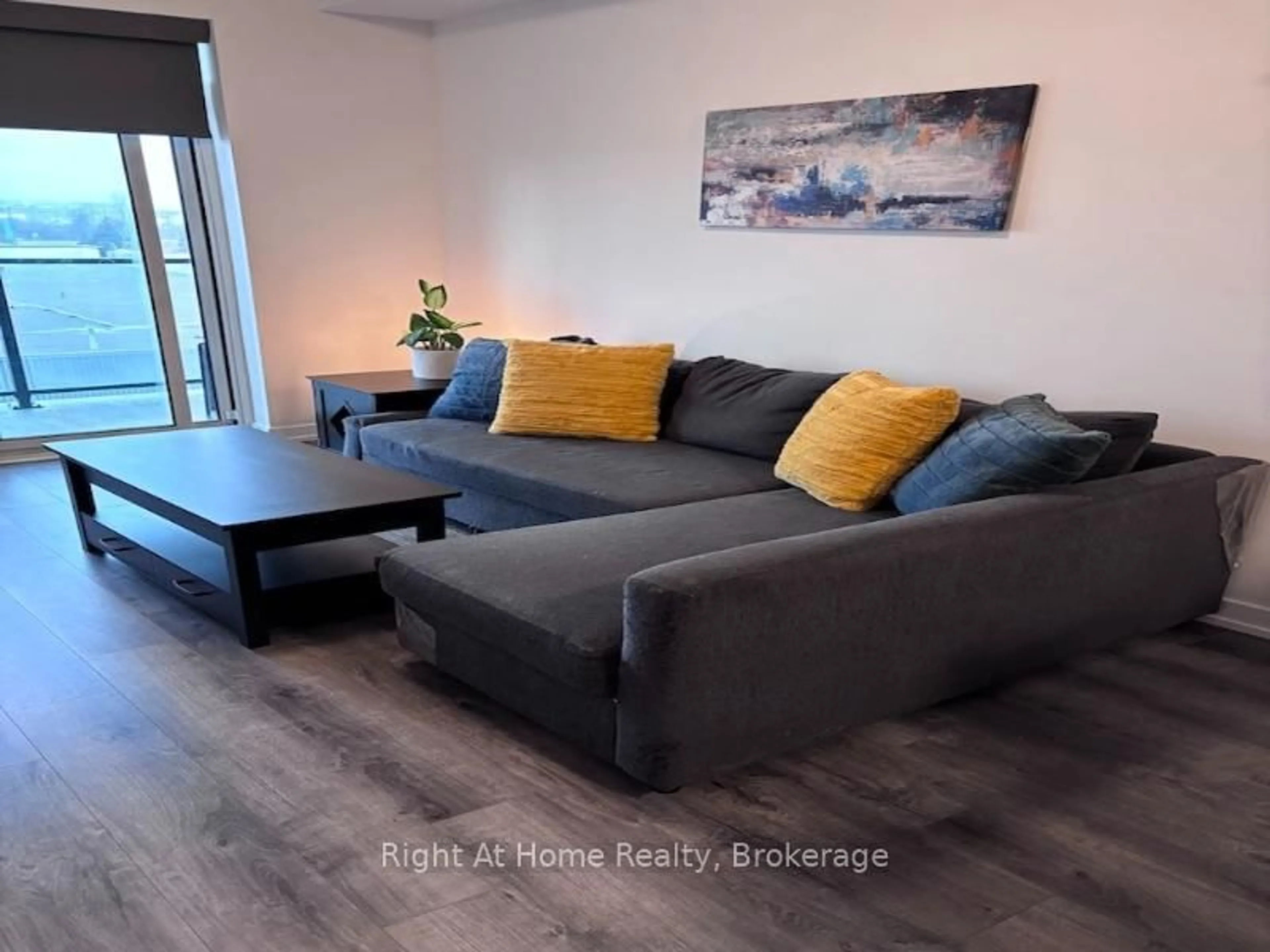 Living room with furniture, wood/laminate floor for 5055 Greenlane Rd #416, Lincoln Ontario L3J 2J3
