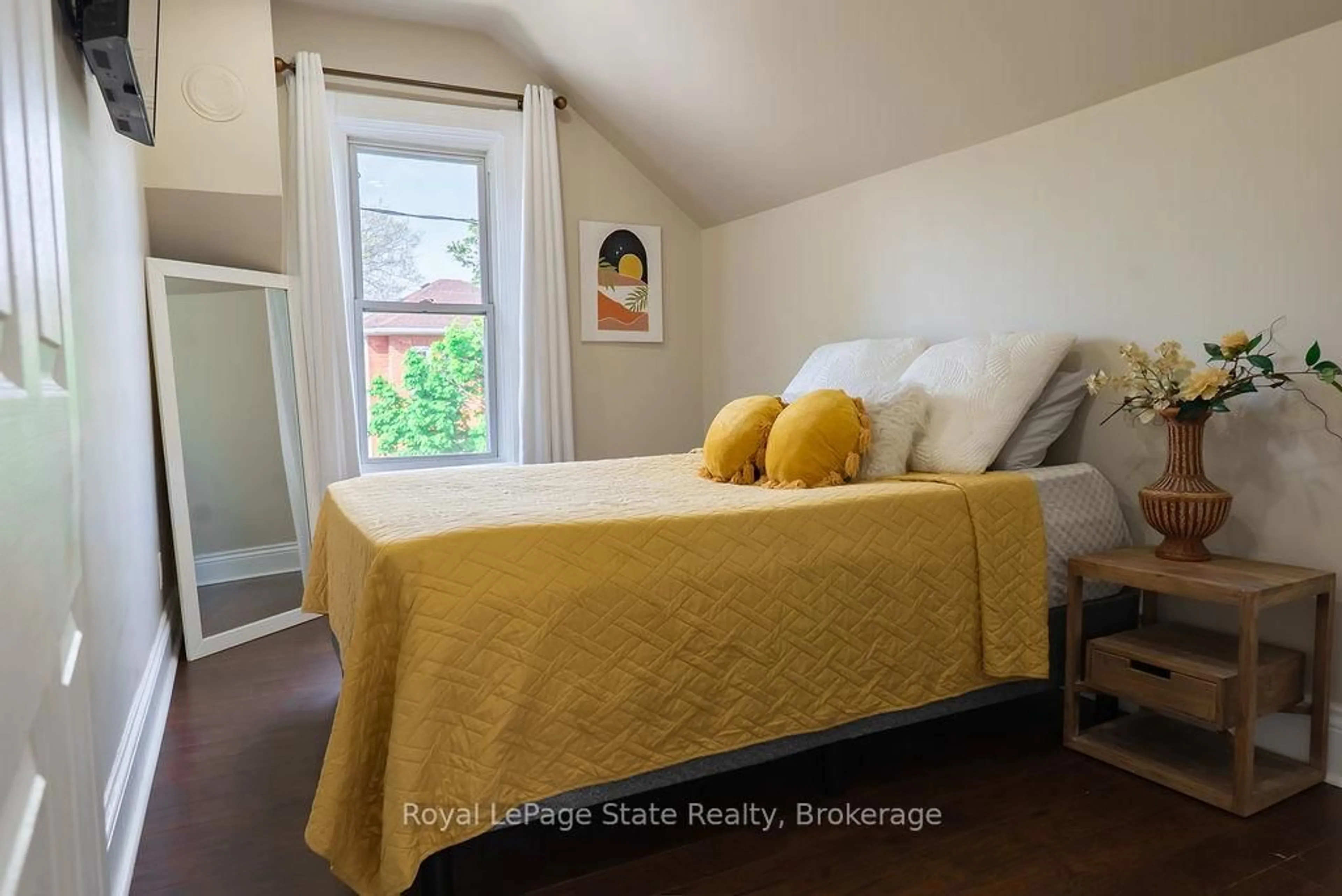 Bedroom with bed, wood/laminate floor for 8 Dundas St, Brantford Ontario N3R 1R8