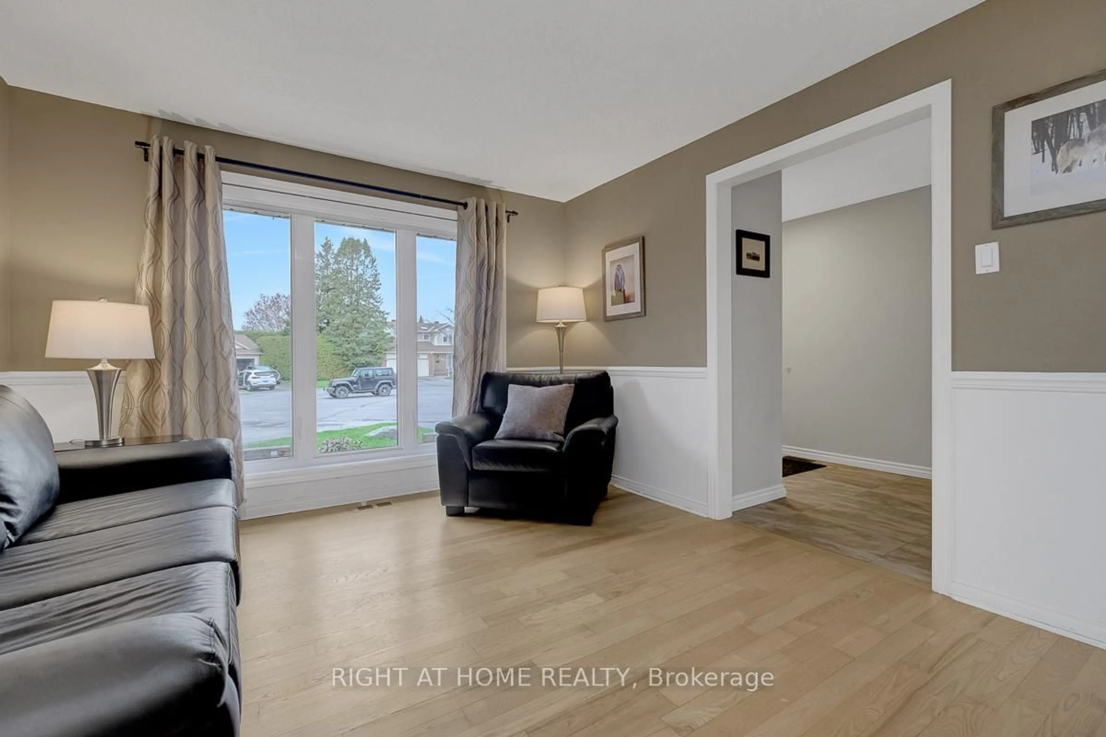 Living room with furniture, wood/laminate floor for 1899 Rosewind Crt, Orleans Ontario K1C 7E3