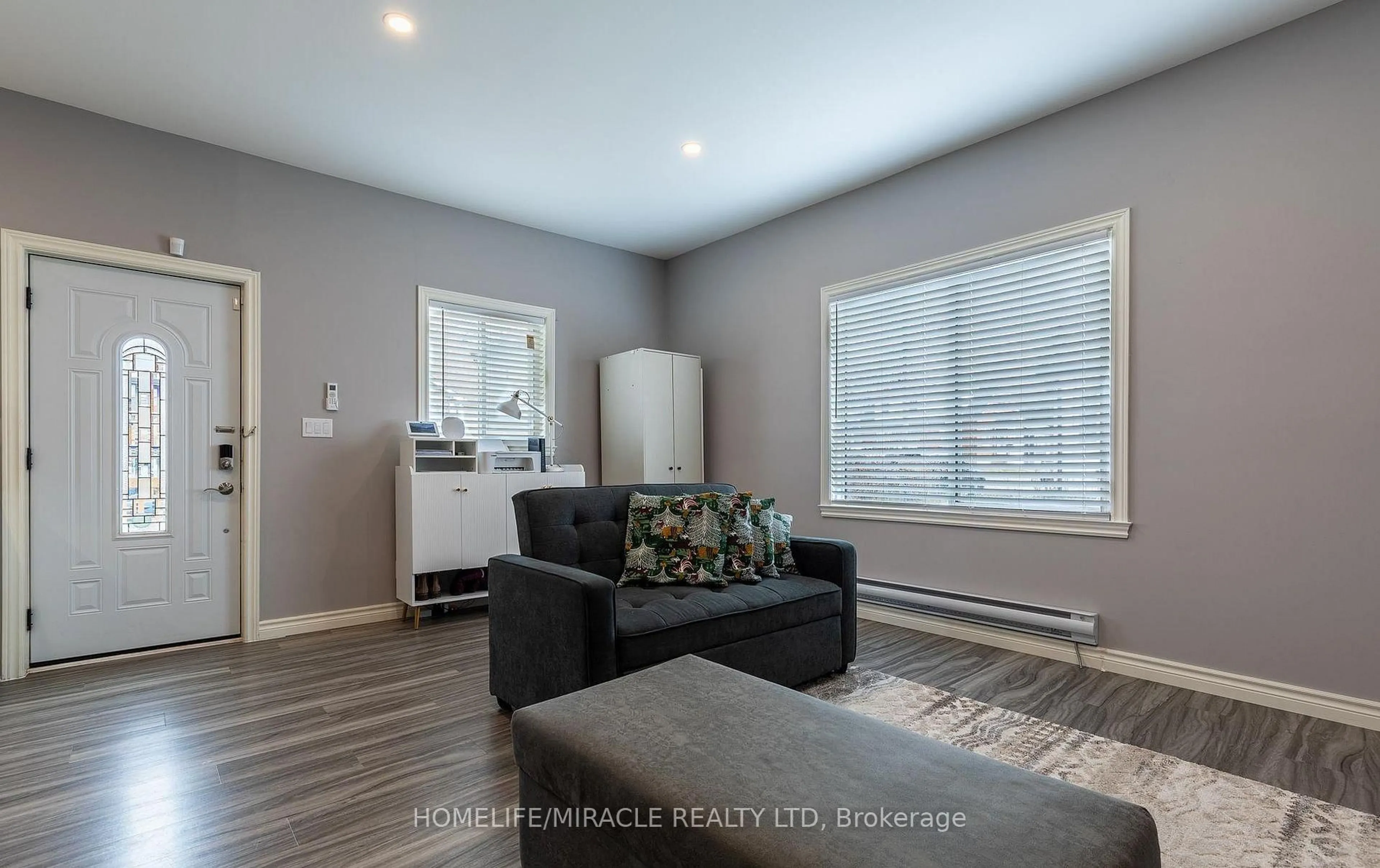 Living room with furniture, wood/laminate floor for 36 Division St, St. Catharines Ontario L2R 3G2