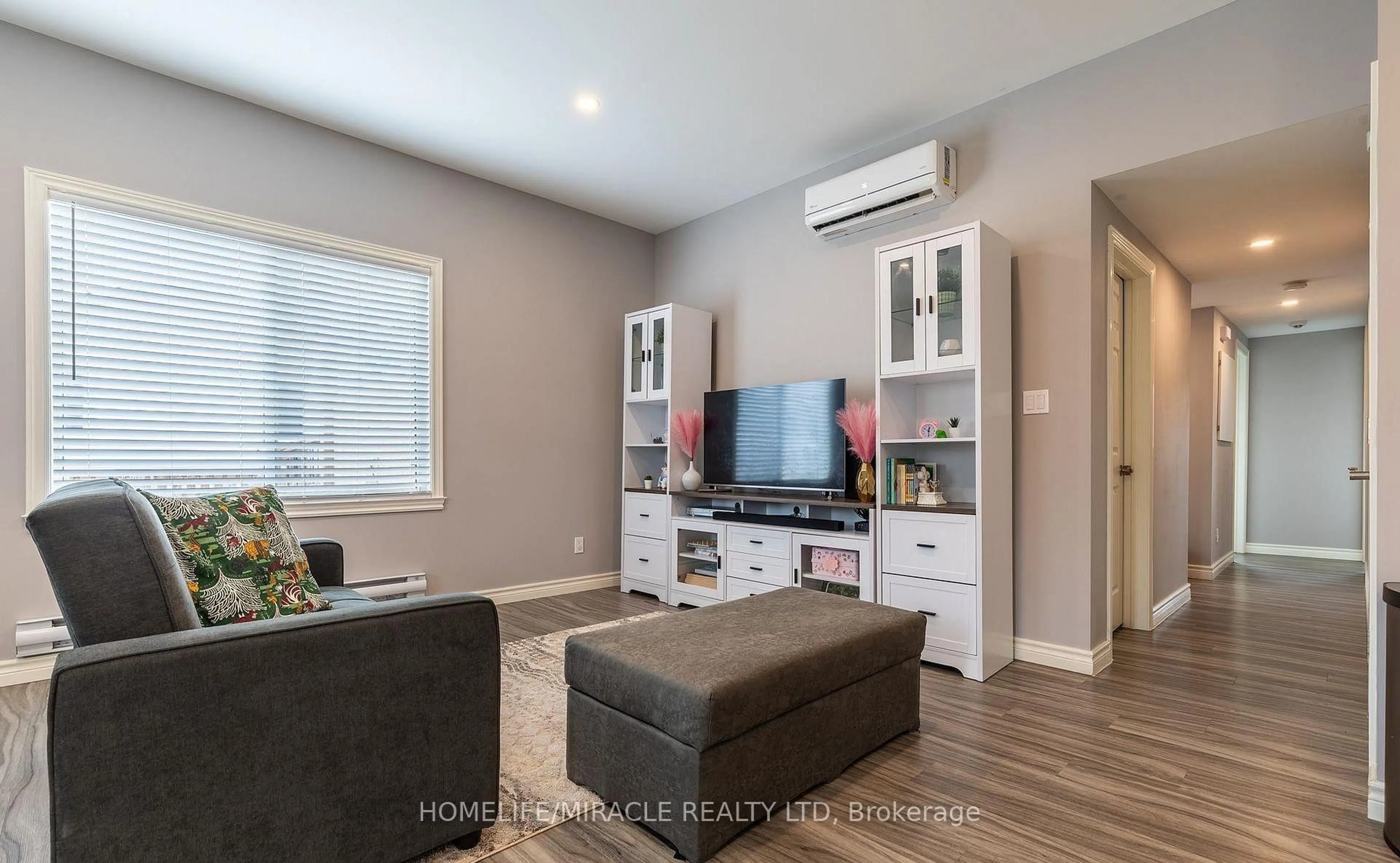 Living room with furniture, wood/laminate floor for 36 Division St, St. Catharines Ontario L2R 3G2