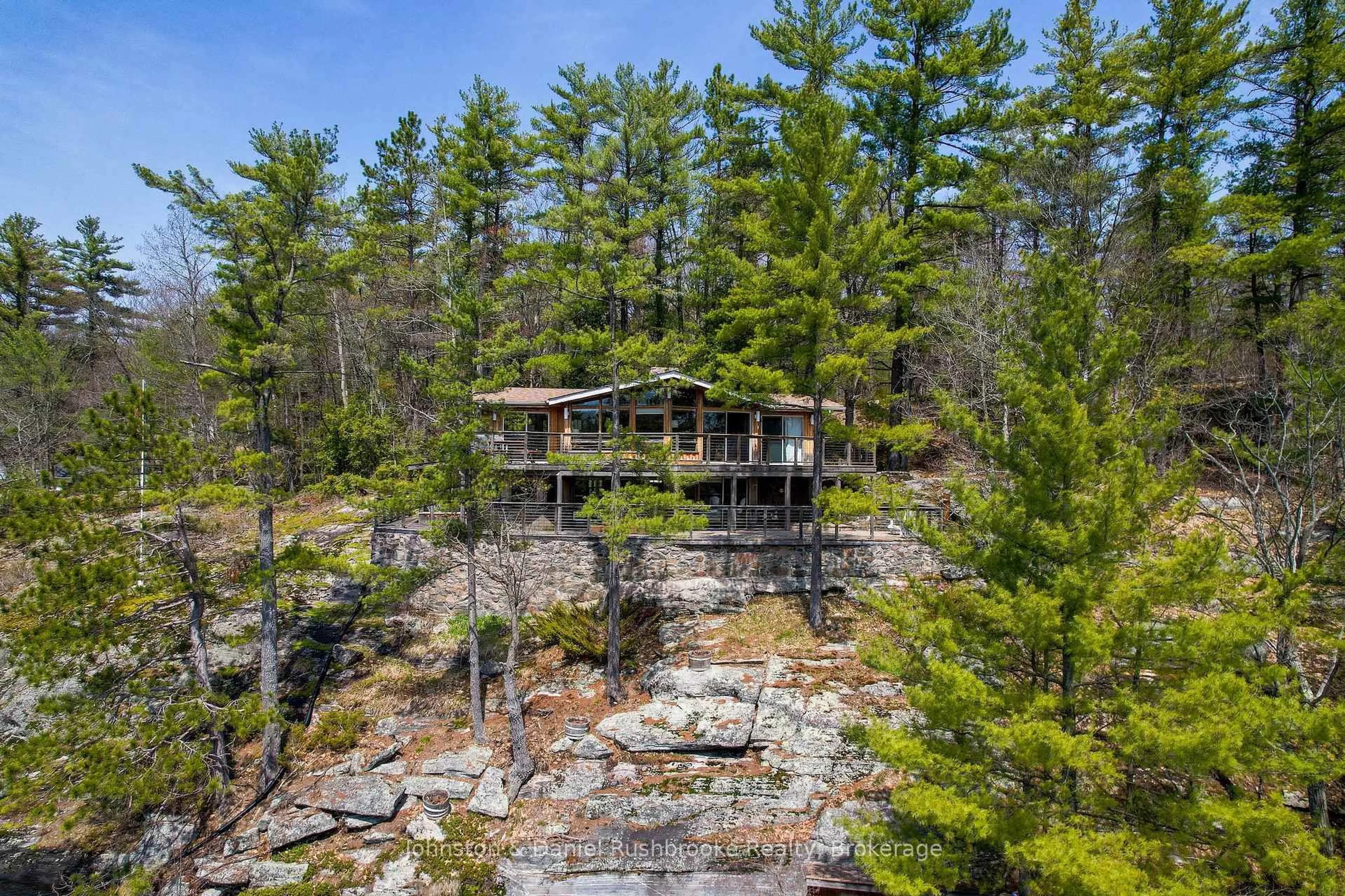 A pic from outside/outdoor area/front of a property/back of a property/a pic from drone, forest/trees view for 1052 North Sunset Bay Rd, Gravenhurst Ontario P1P 1R2