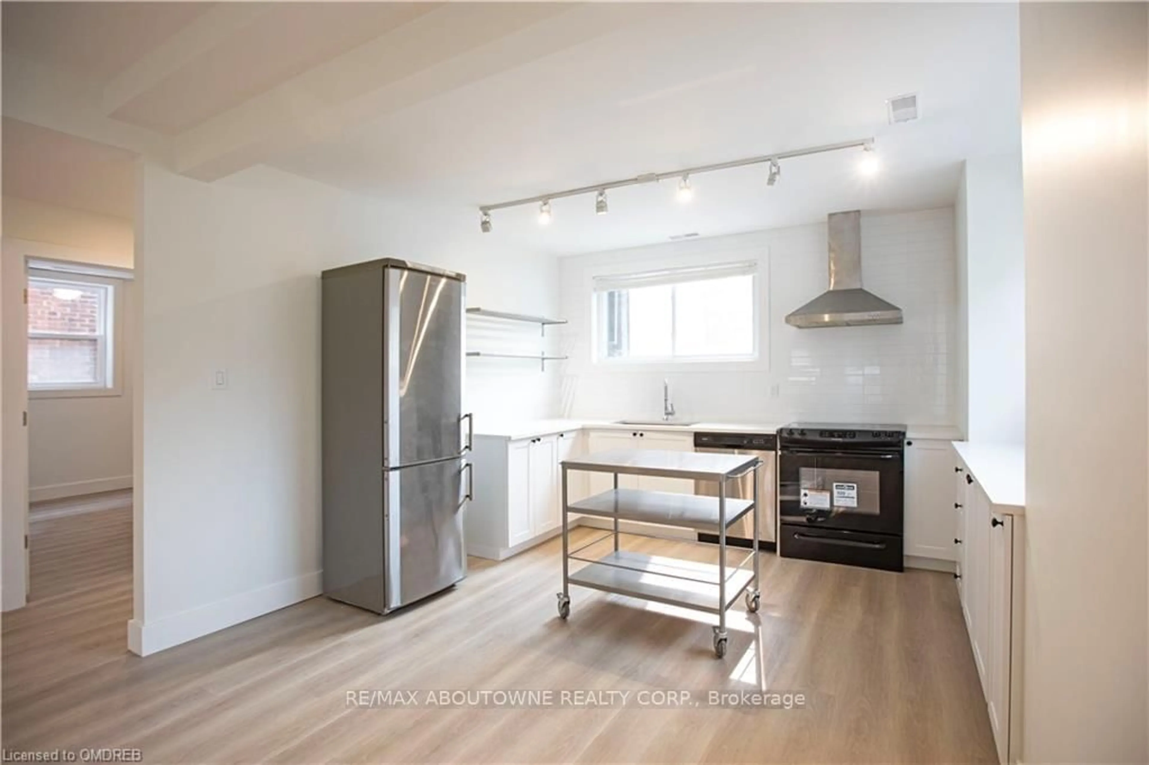 Open concept kitchen, wood/laminate floor for 49 Fairleigh Ave, Hamilton Ontario L8M 2K1