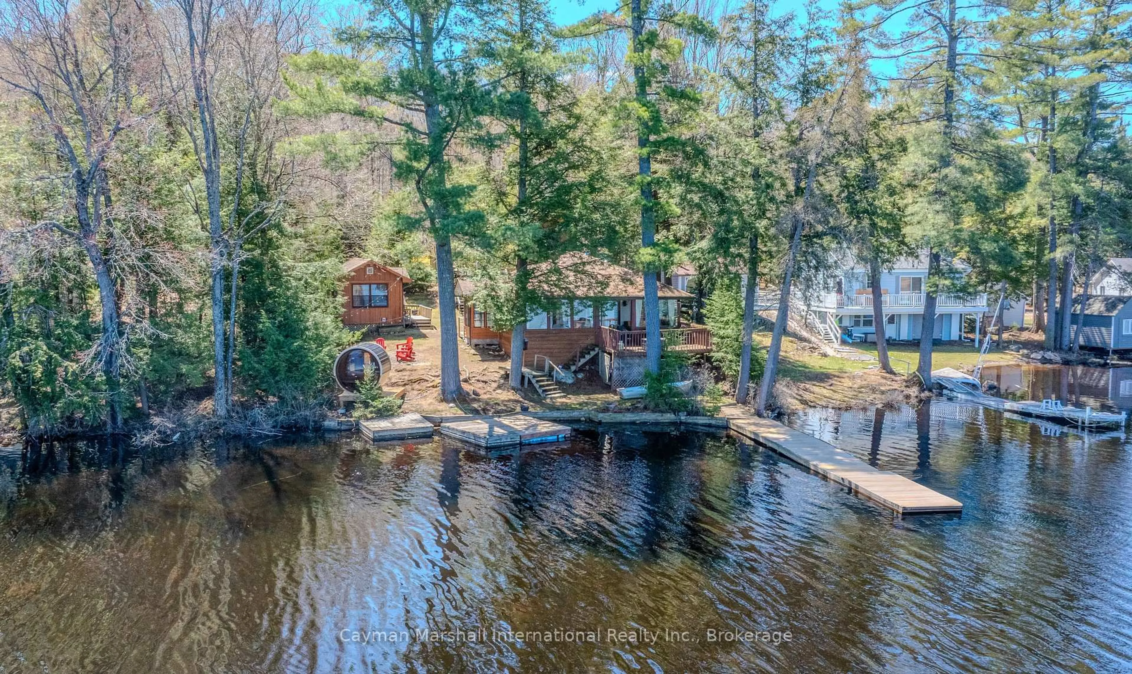 A pic from outside/outdoor area/front of a property/back of a property/a pic from drone, water/lake/river/ocean view for 1065 Rainbow Lane, Bracebridge Ontario P1L 1X3