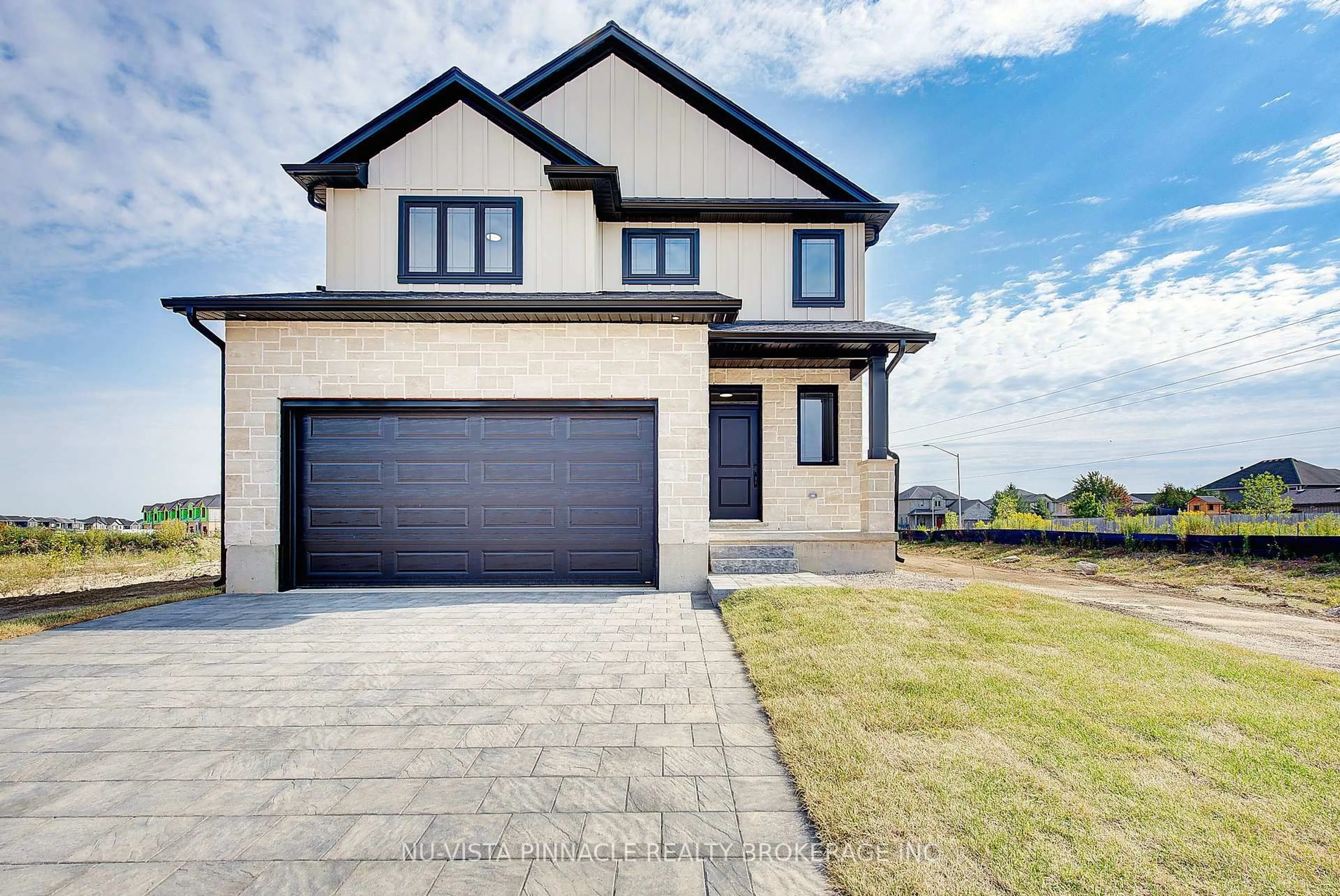 Home with brick exterior material, street for 10 Woodmere Path, Middlesex Centre Ontario N0M 2A0