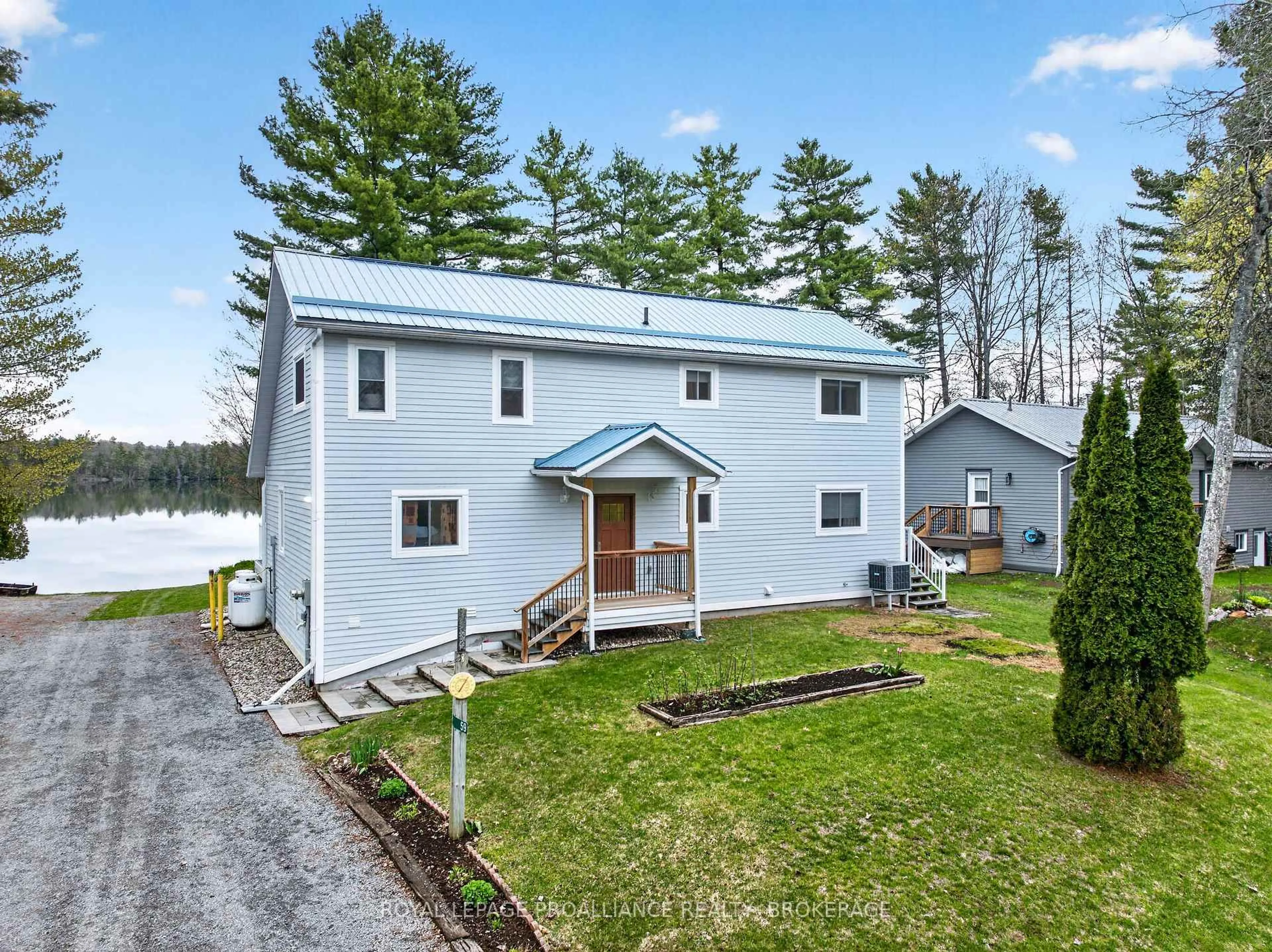 A pic from outside/outdoor area/front of a property/back of a property/a pic from drone, water/lake/river/ocean view for 59 West Shore Lane, Godfrey Ontario K0H 1T0